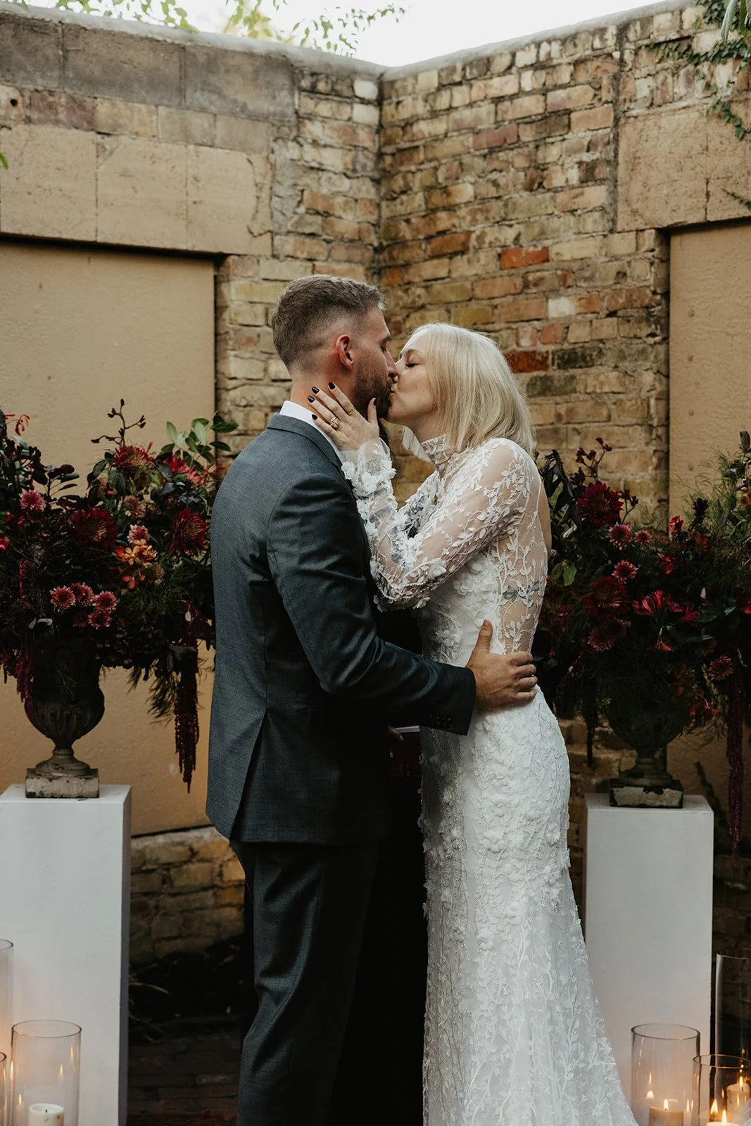  Newlyweds sharing a kiss at their intimate ceremony. 
