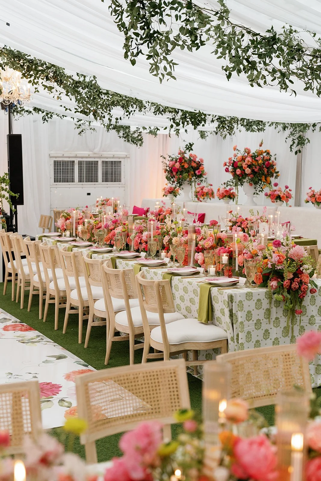  Long reception tables set beneath trailing smilax and a crystal chandelier at Woodbine Mansion 