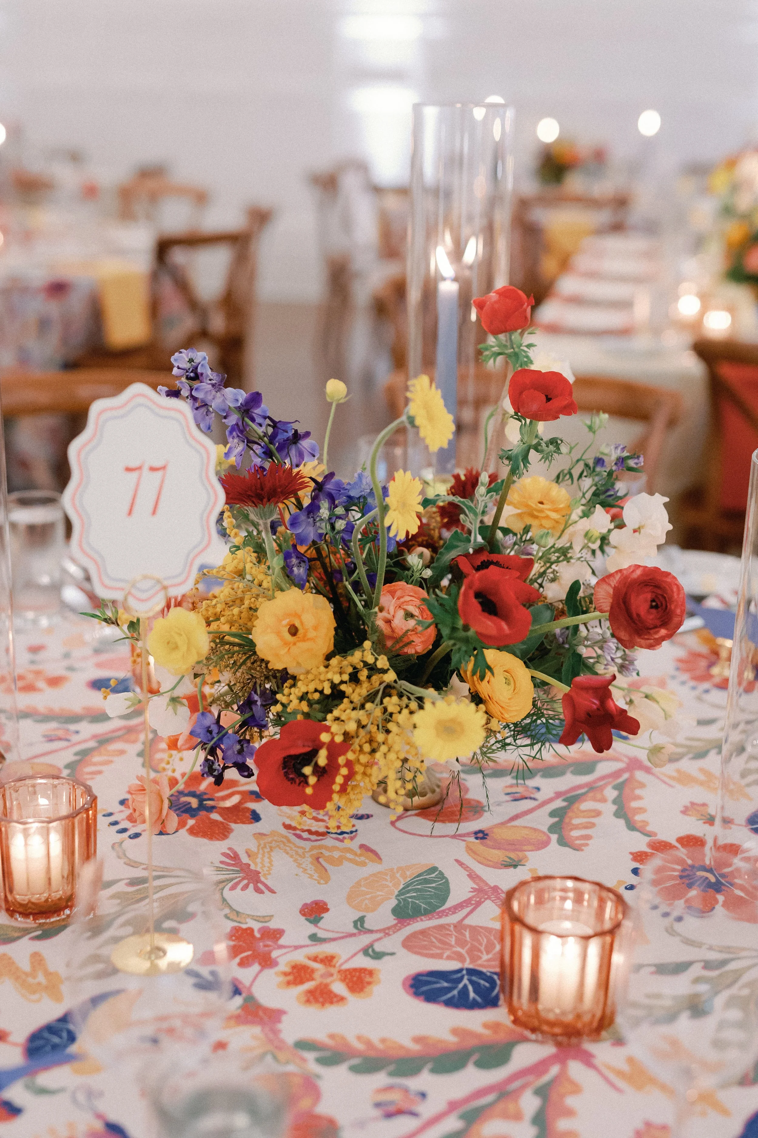  Table number sign beside a colorful floral centerpiece on a floral-patterned tablecloth at Mattie's 