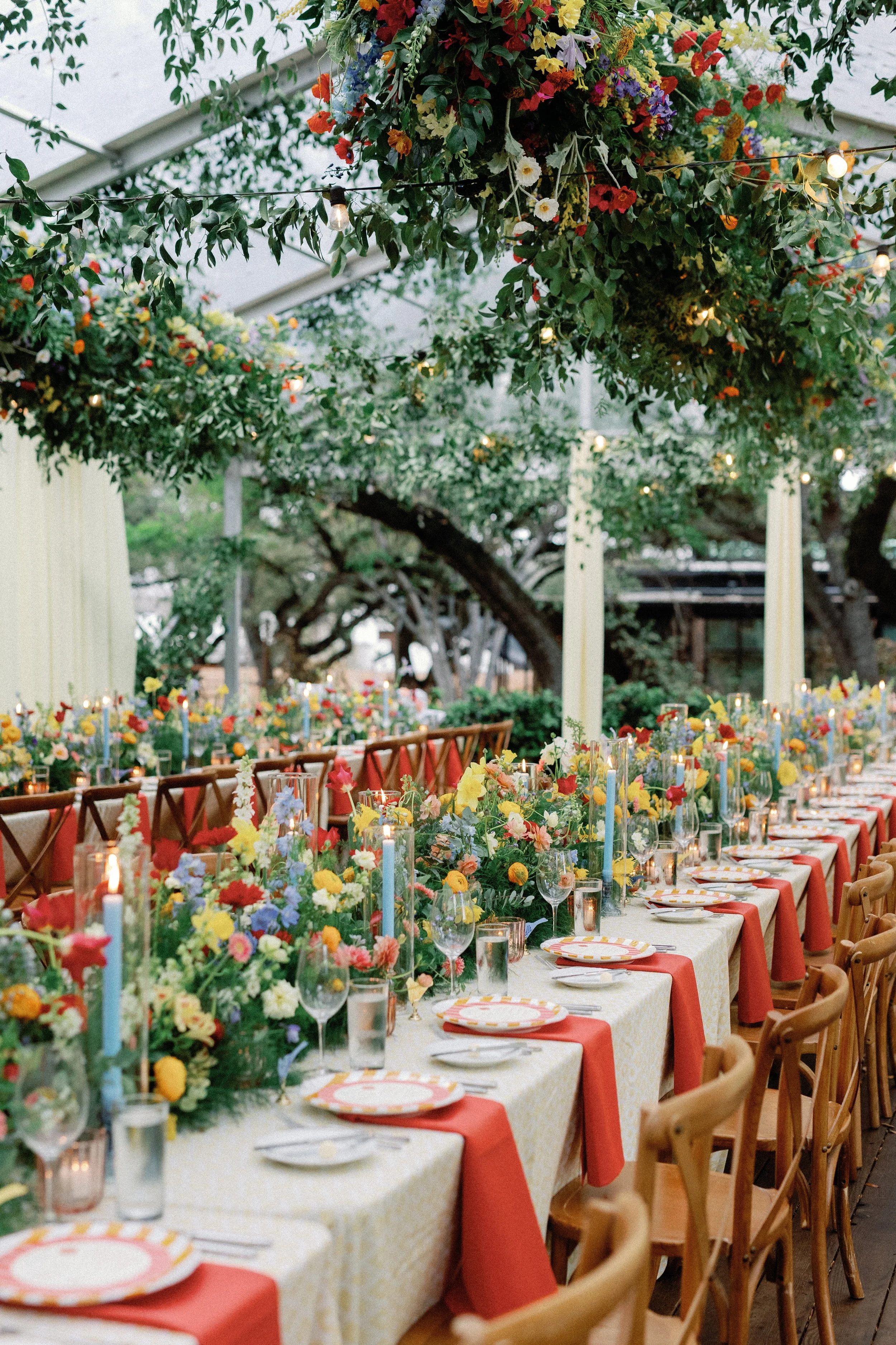  View down a long reception table beneath a hanging greenery and floral garland canopy at Mattie's 