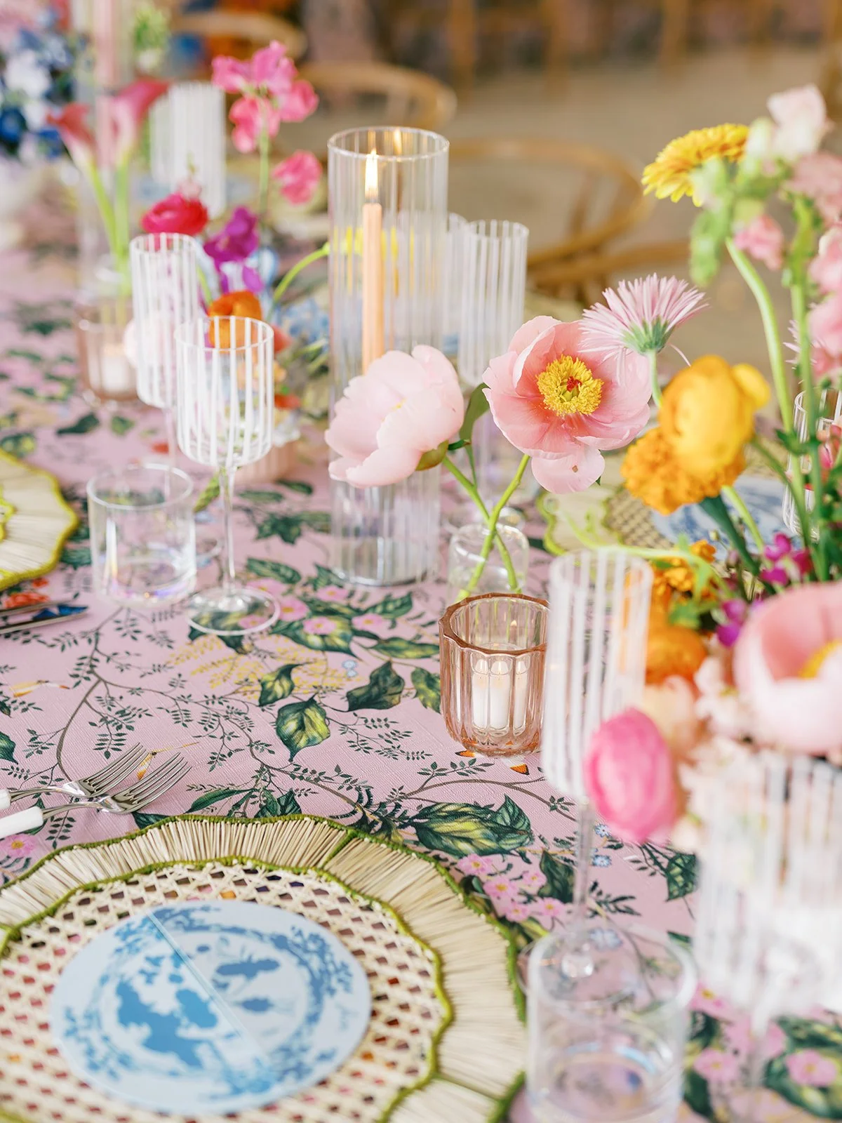  Reception table setting with floral print linen, blue and white plate, and colorful florals 