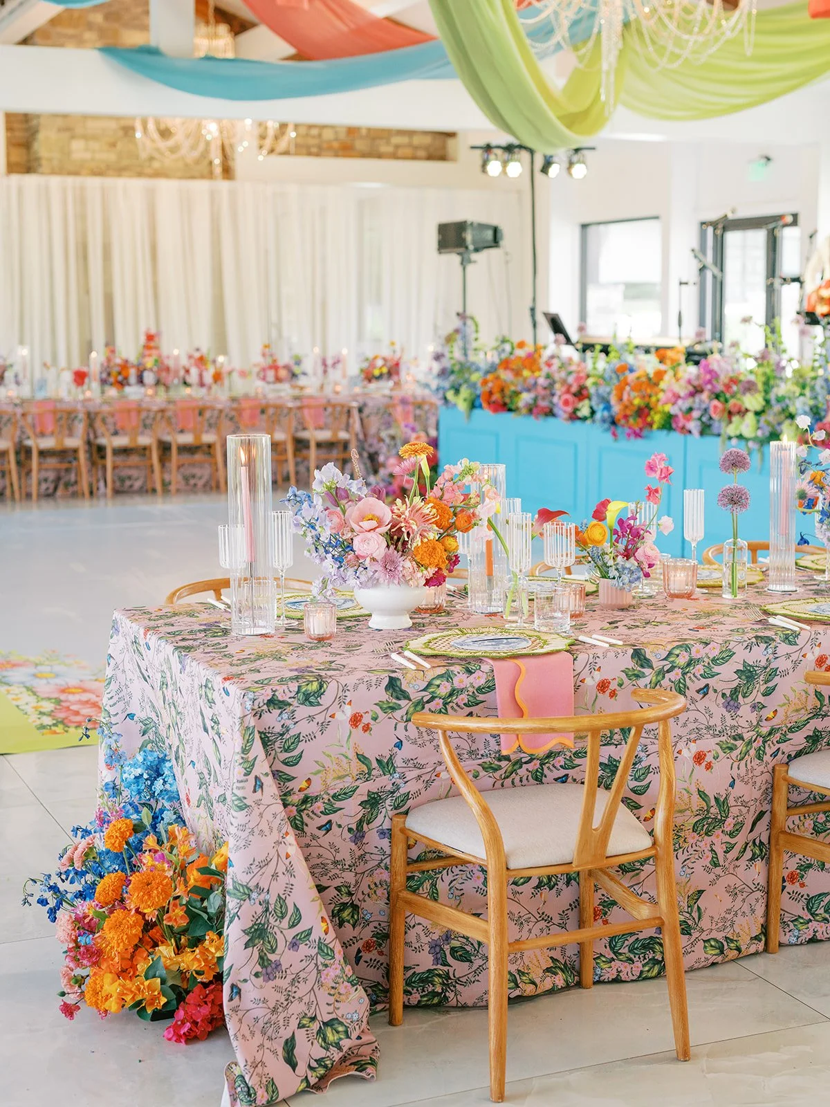  Wide view of the Videre Hall reception room with a colorful draped ceiling above the tables 