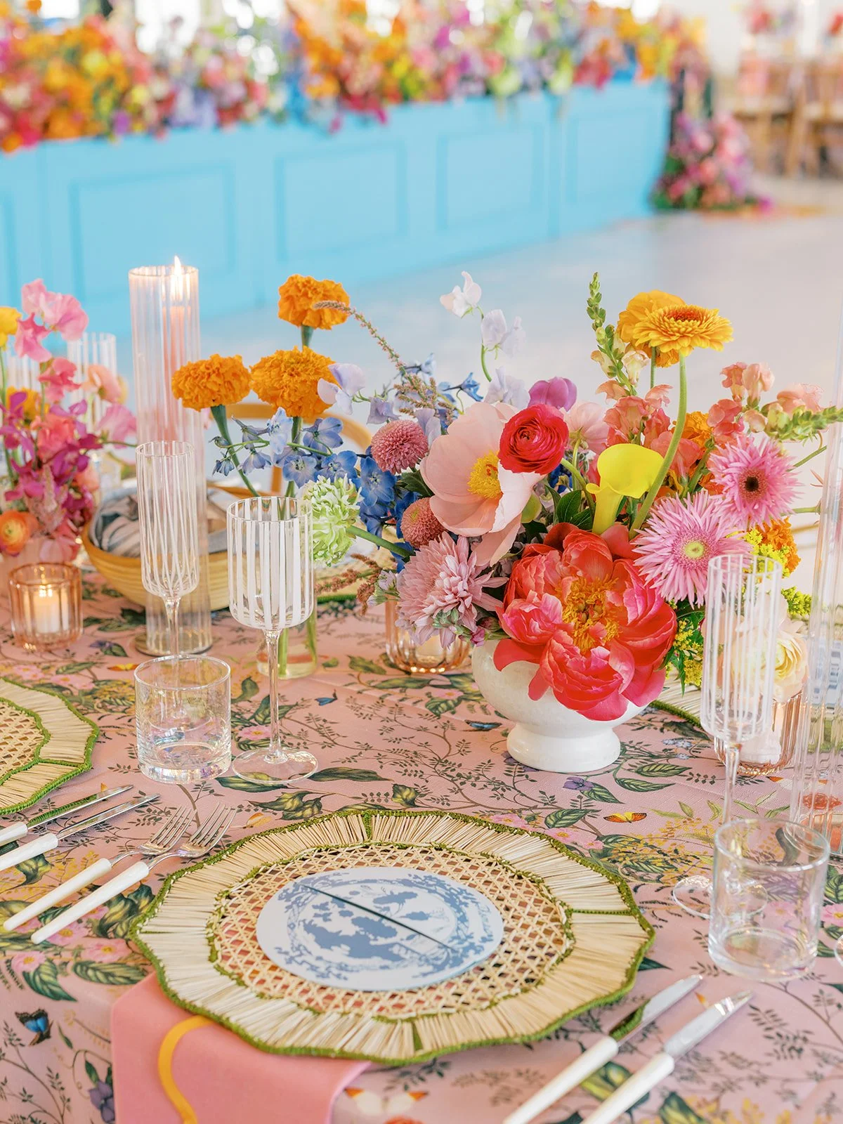  Videre Estate reception room with a teal accent wall, colorful centerpiece, and candlelight 
