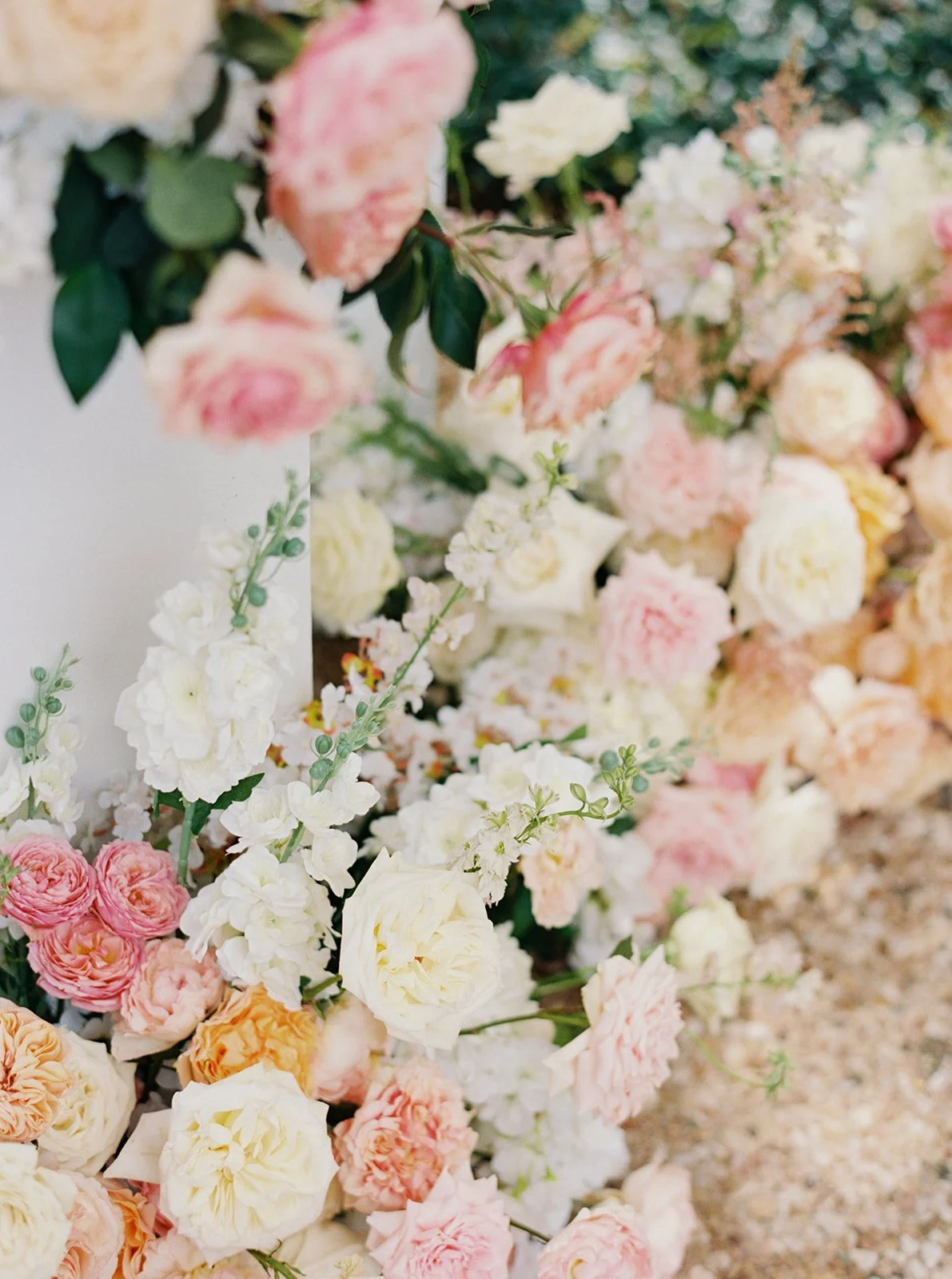  Wedding ceremony flowers spilling onto the courtyard at Commodore Perry Estate, designed by Remi + Gold 