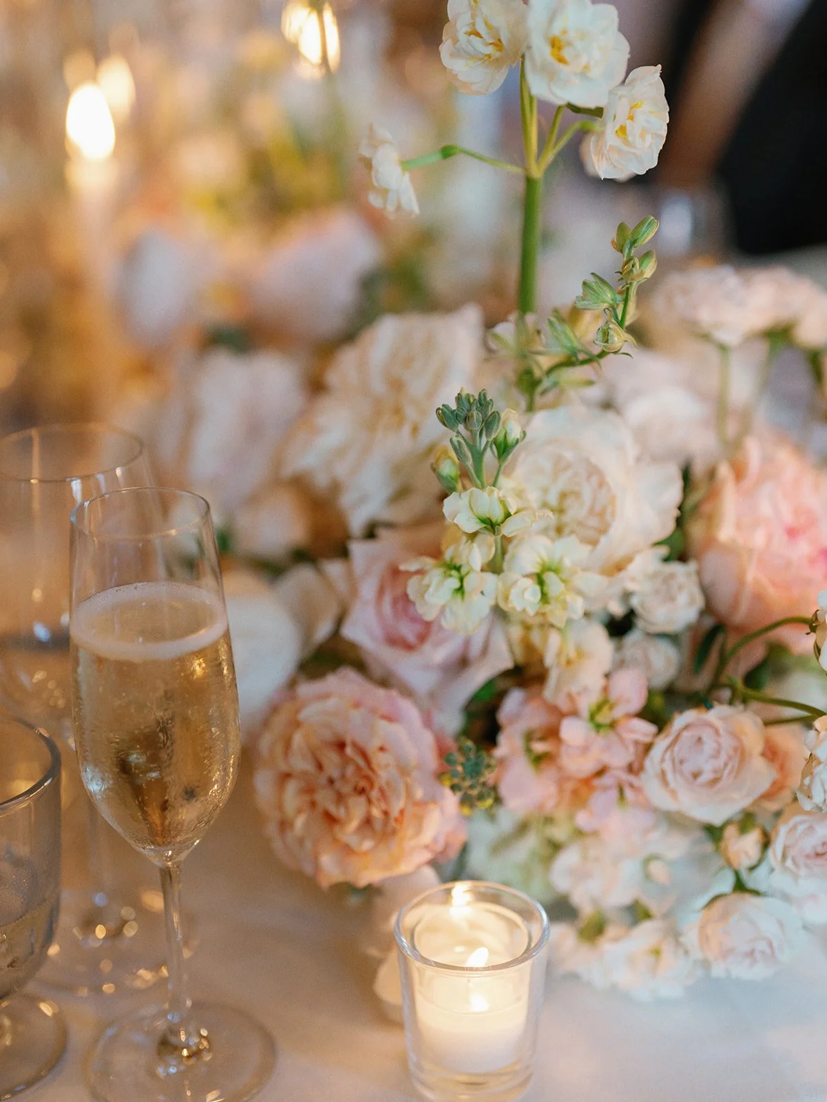  Candlelit wedding reception at Commodore Perry Estate in Austin with blush and peach floral centerpieces by Remi + Gold 