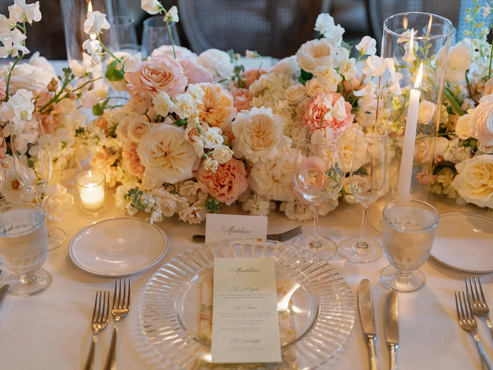  Blush, peach and ivory wedding reception florals with taper candles in glass hurricanes at Commodore Perry Estate 