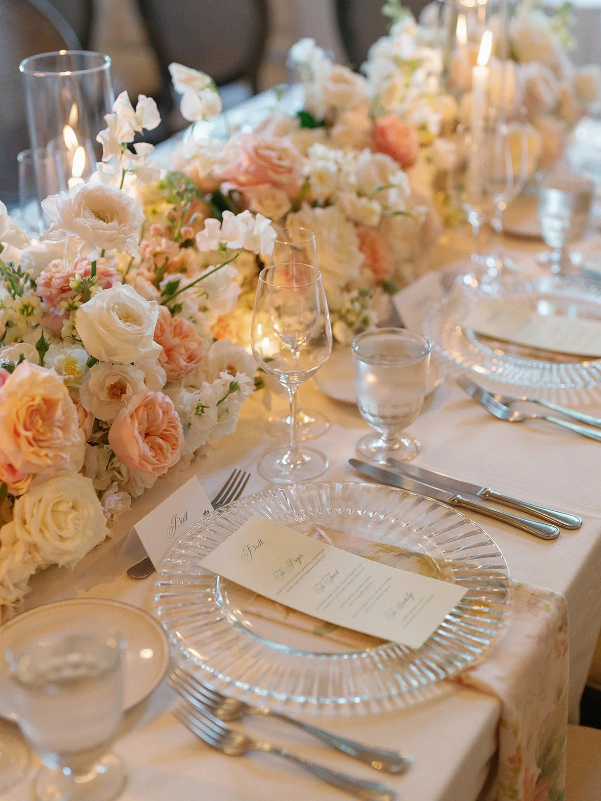  Wedding reception tables under a glass chandelier at Commodore Perry Estate, with florals by Remi + Gold 