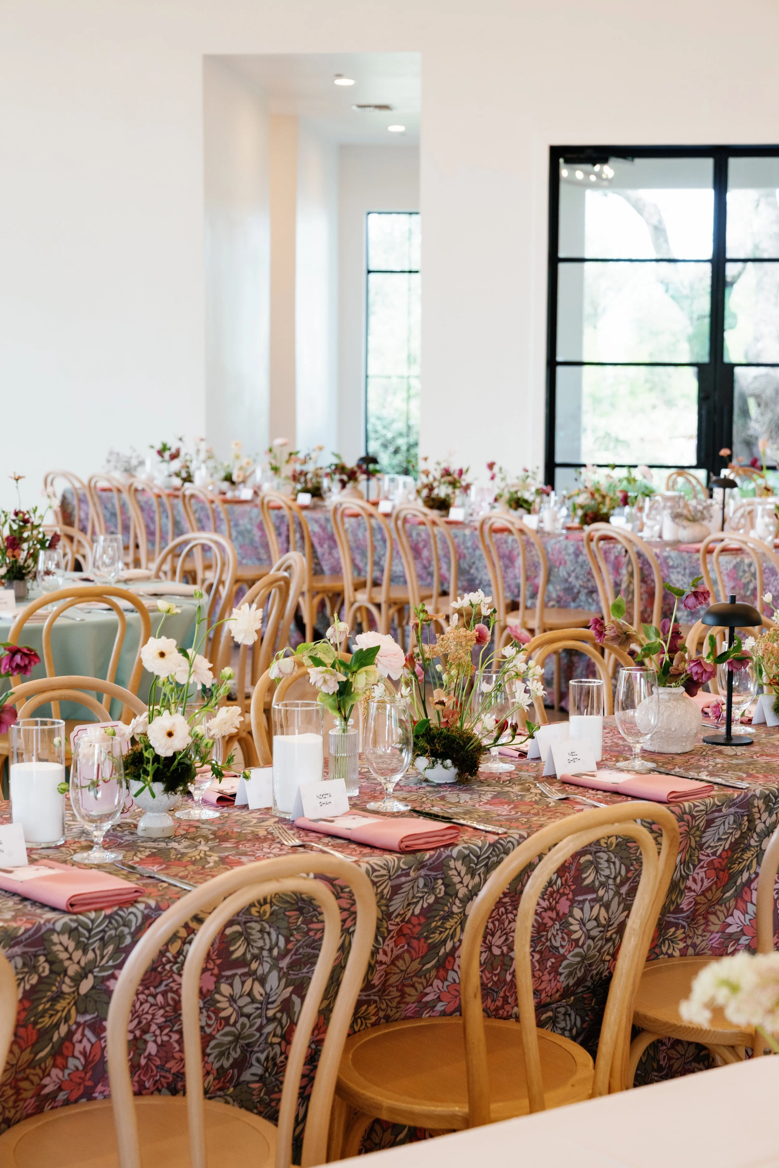  Long reception tables with mauve patterned linens and garden rose bud vases at The Arlo 