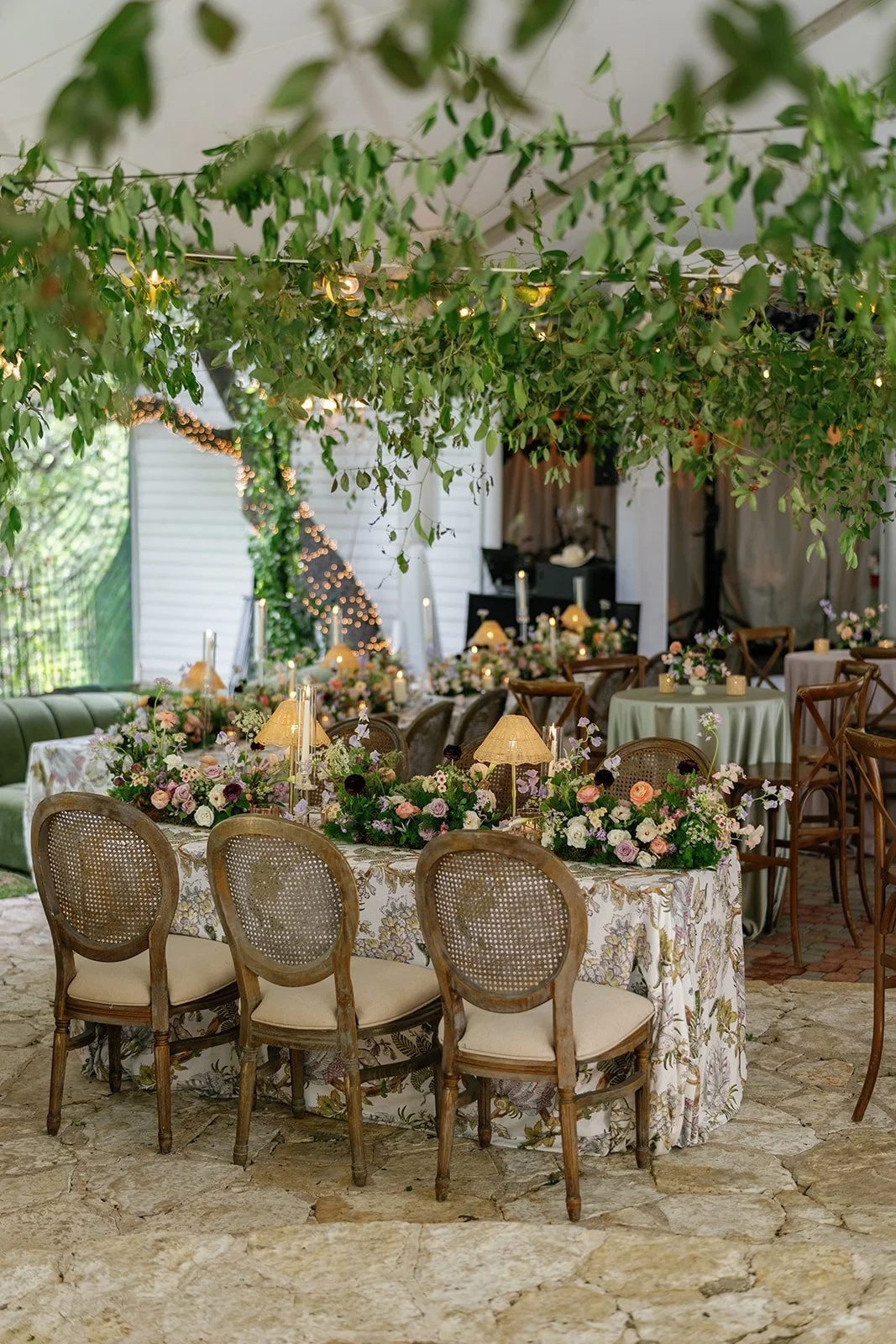  Hanging greenery installation over a tented wedding reception in downtown Austin at The Allan House 