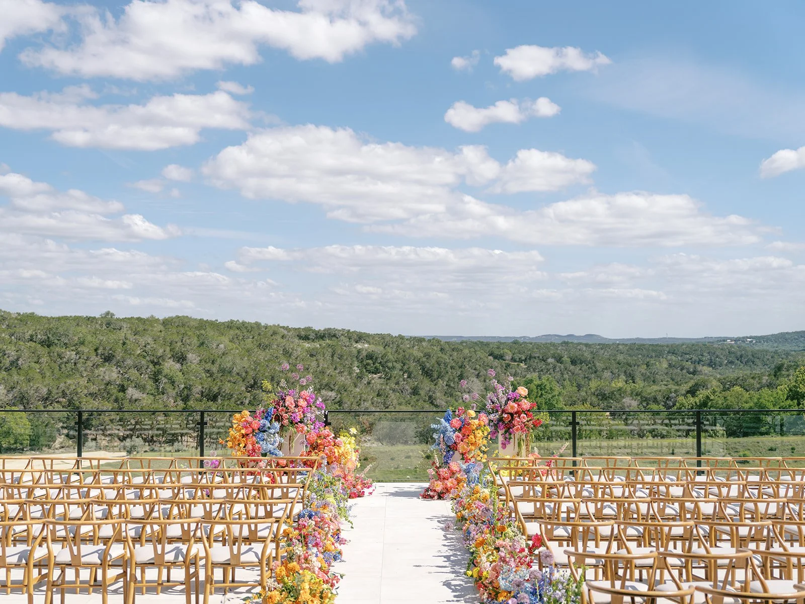 Gorgeous and colorful ceremony view at the Videre Estate with bright florals