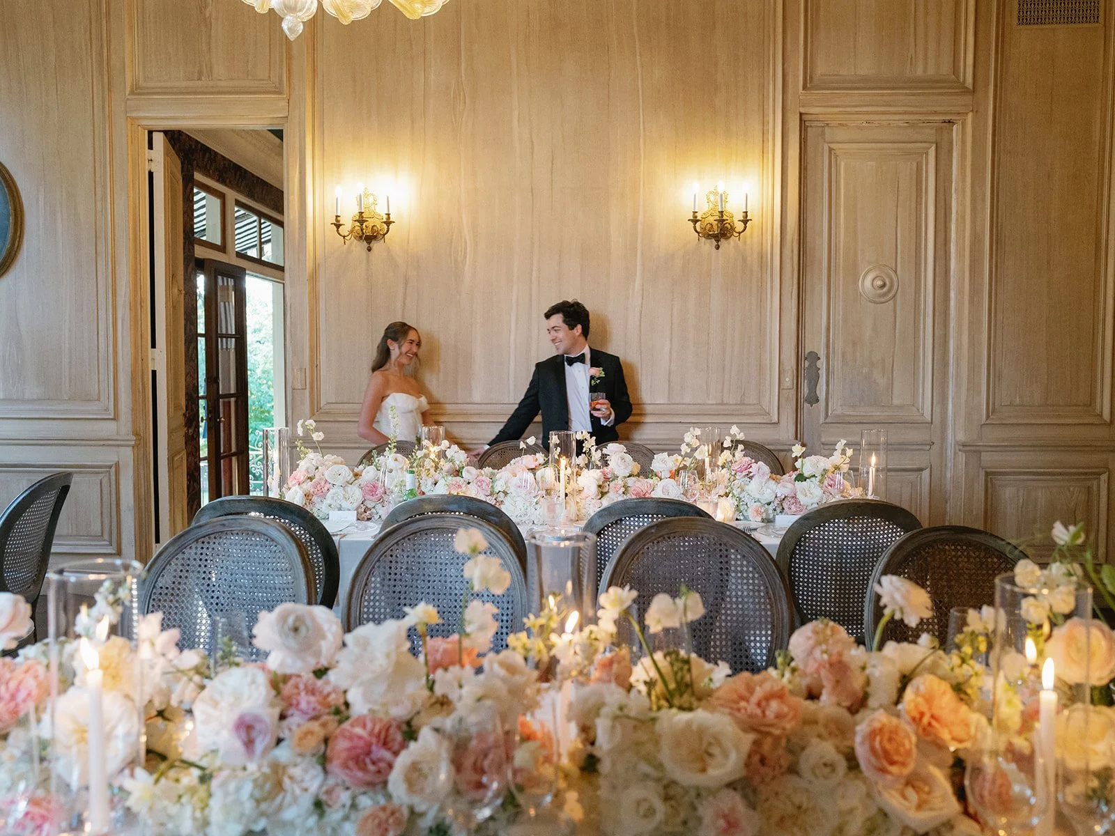 Candlelit reception tables with garden rose centerpieces at Commodore Perry Estate in Austin