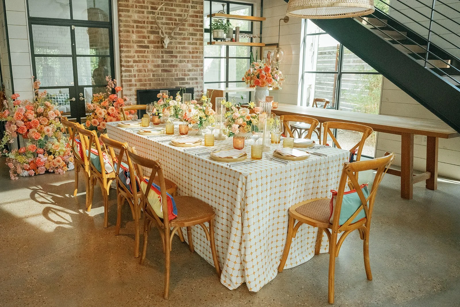 A beautiful view of summer corporate event florals designed perfectly for this tablescape and this space in Austin.