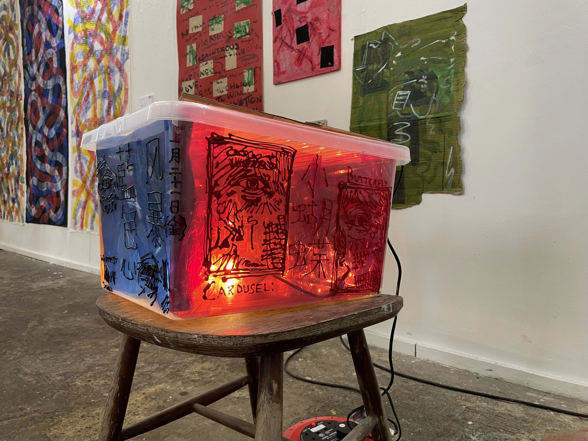 For an exhibition piece, I painted my icing paintings onto a box and attached a light bulb inside to project the paintings onto the wall. I stuck pieces of coloured cellophane inside the box so it would project the colours as well as the paintings on