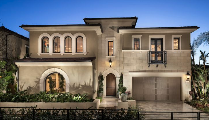 Modern two-story house with arched and rectangular windows, a garage, and a small balcony, surrounded by greenery.