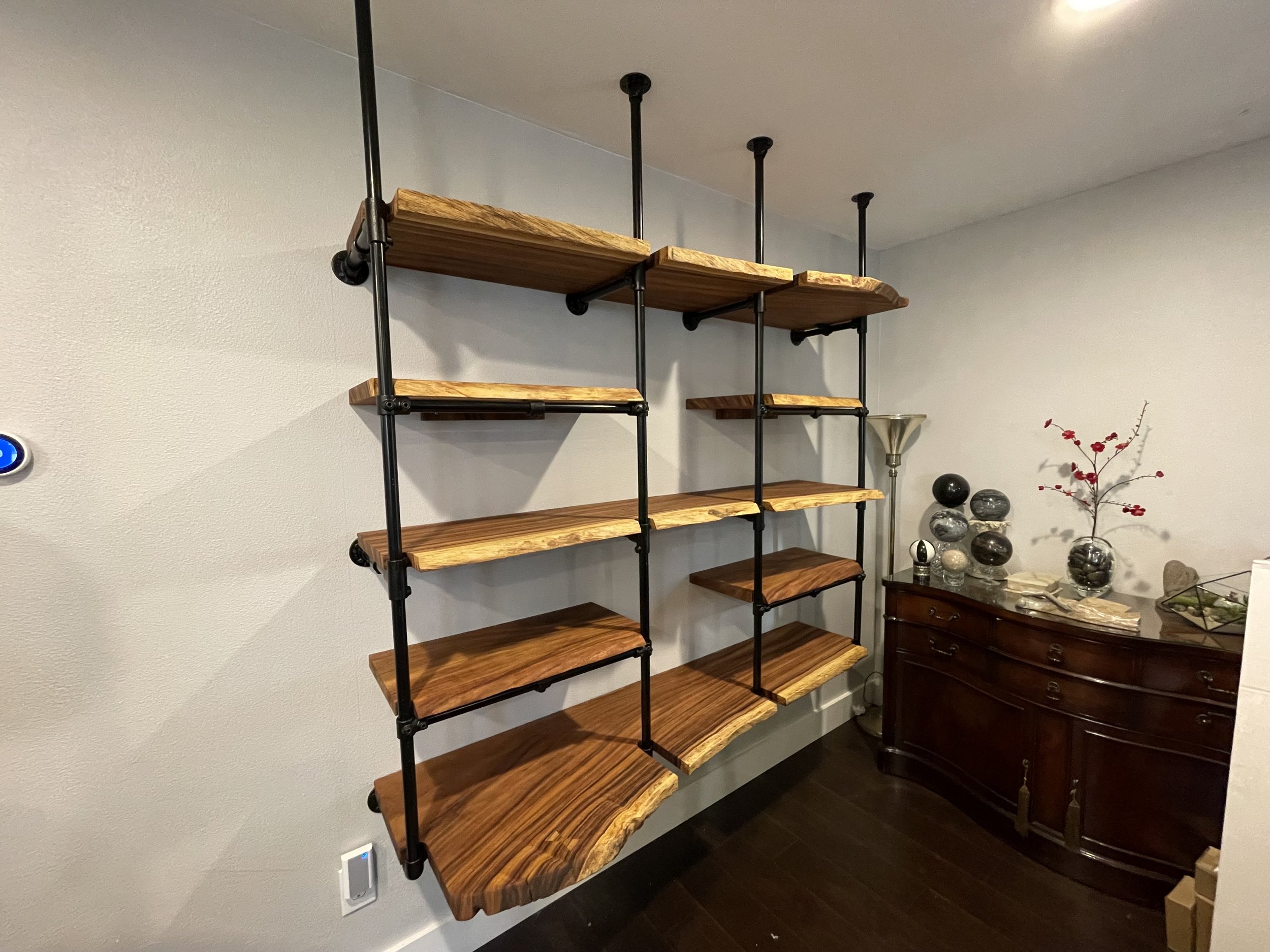 Costa Rican Monkey Pod live edge shelving · Industrial pipe hardware · Custom wall install