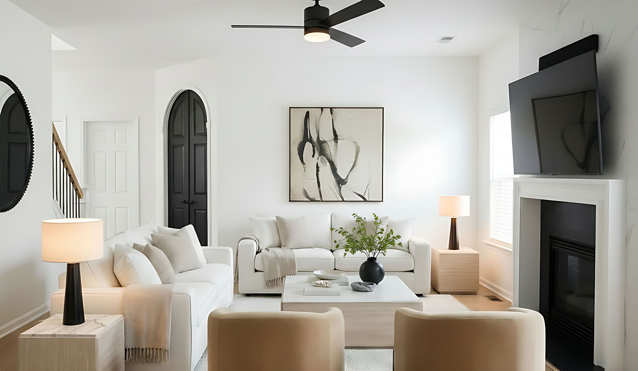 A woman in beige pants and coat standing in an empty, modern living room with light-colored wood flooring, a white marble fireplace, black framed windows, and a staircase with black railing.