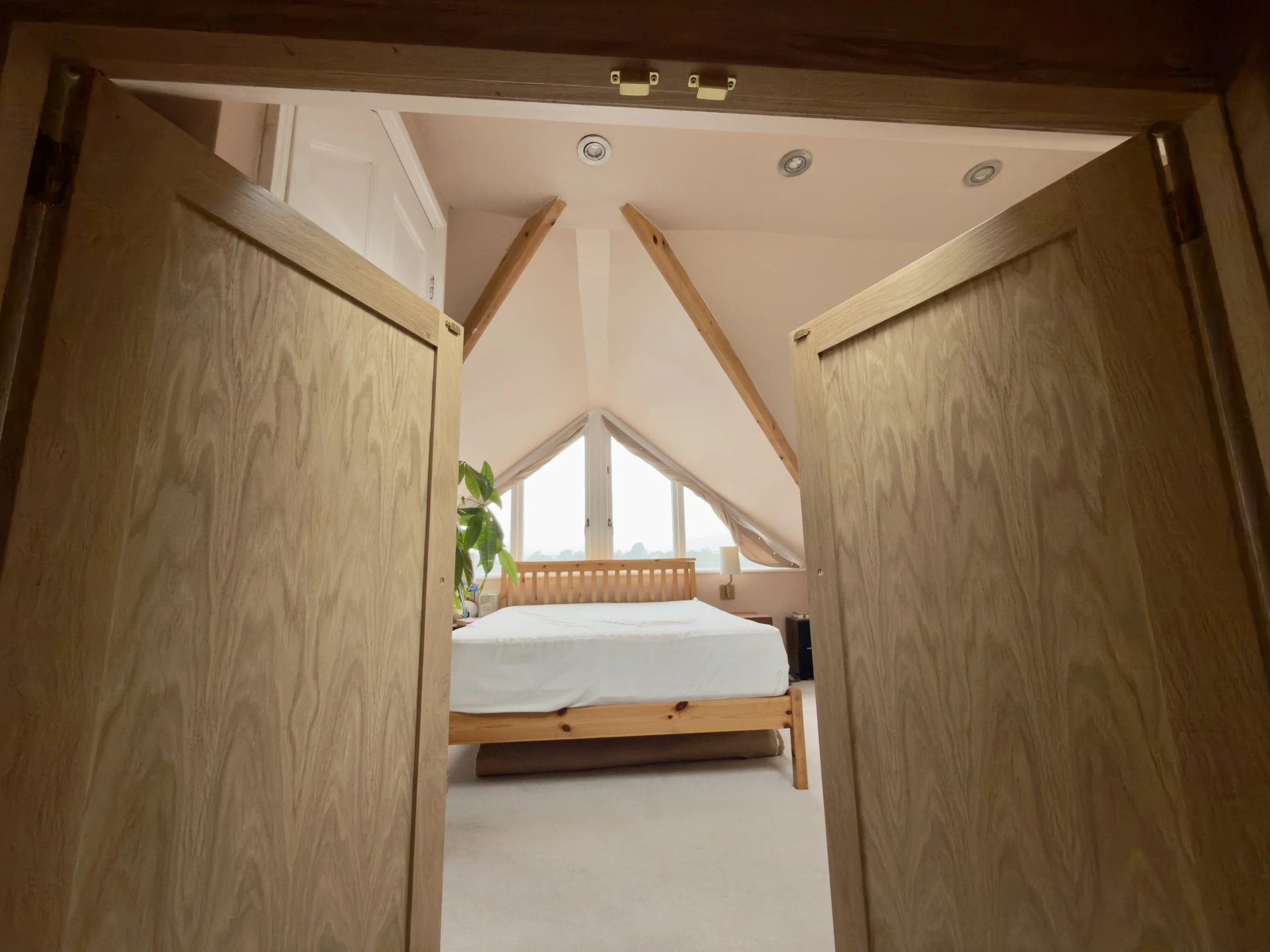 Bespoke oak wardrobe. Opening doors.