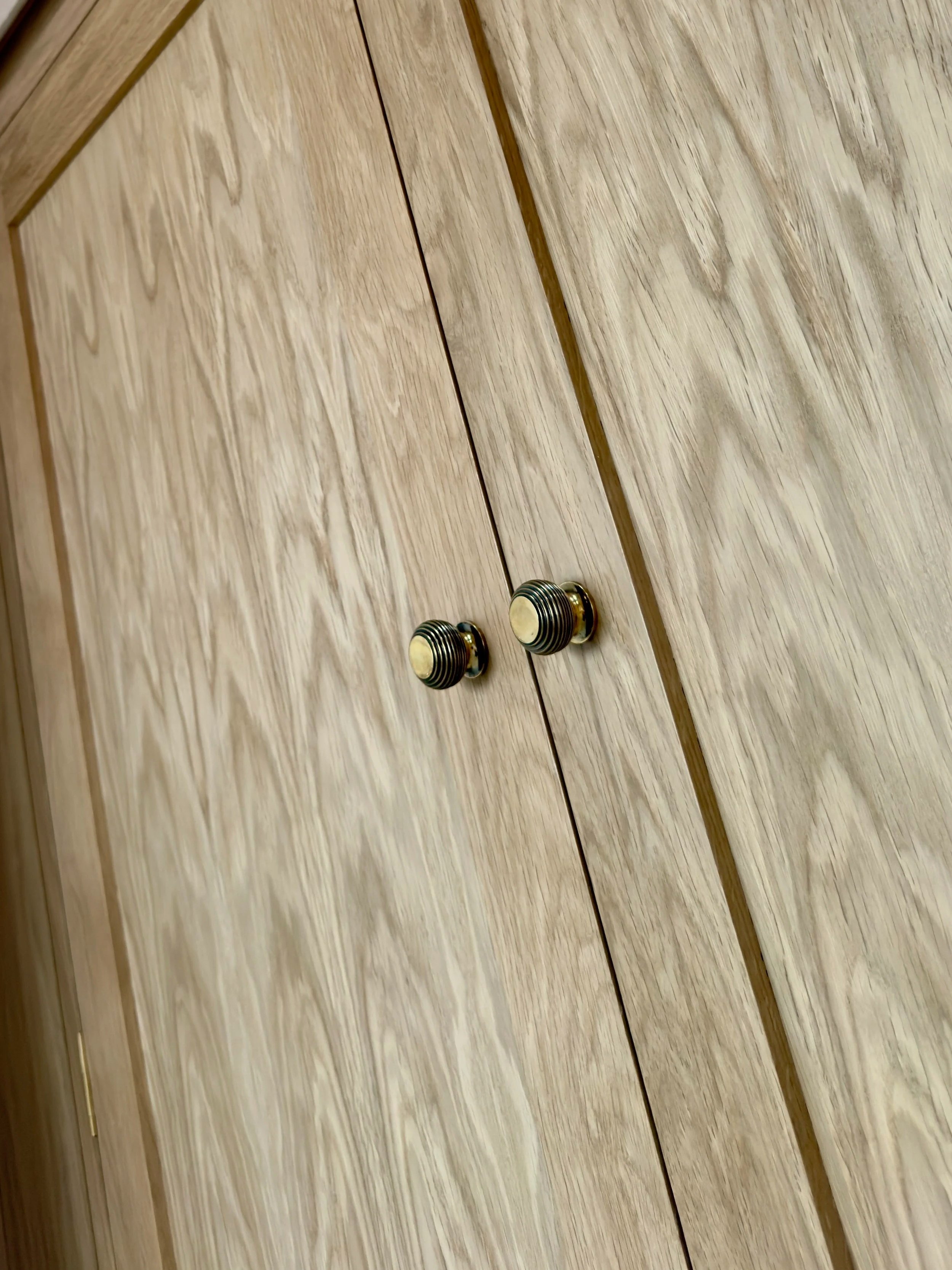Bespoke oak wardrobe. Brass knobs, premium solid oak and oak veneer panels. 