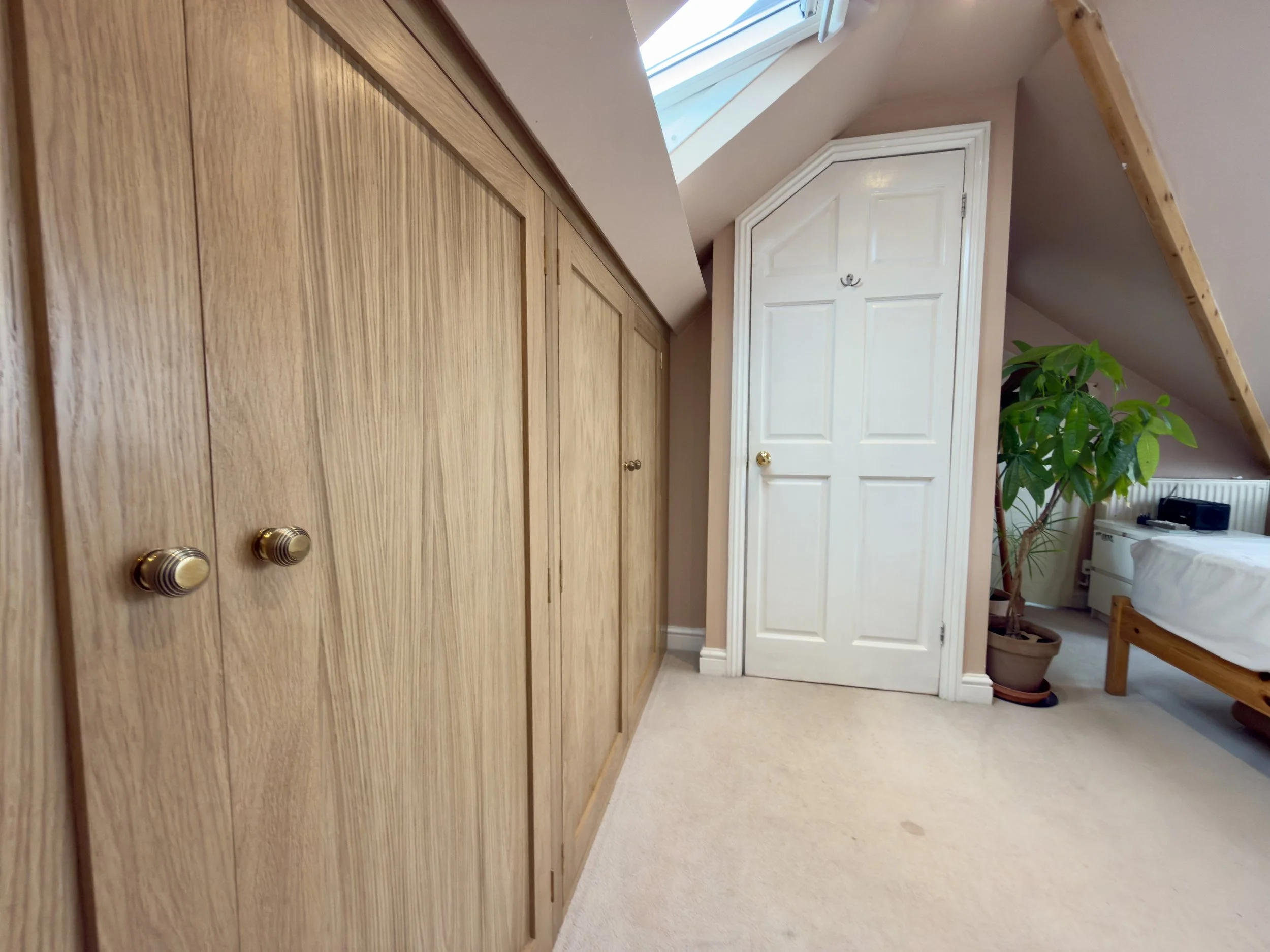 Bespoke oak wardrobe in loft bedroom.