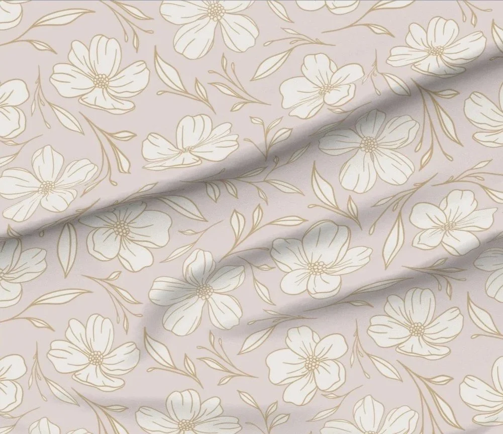 Floral surface design  in soft beige and cream tones featuring delicate outlined flowers and leaves on smooth fabric. The fabric style blends cottagecore soft style with new heritage and southern influences, shown without furniture or decor visible.