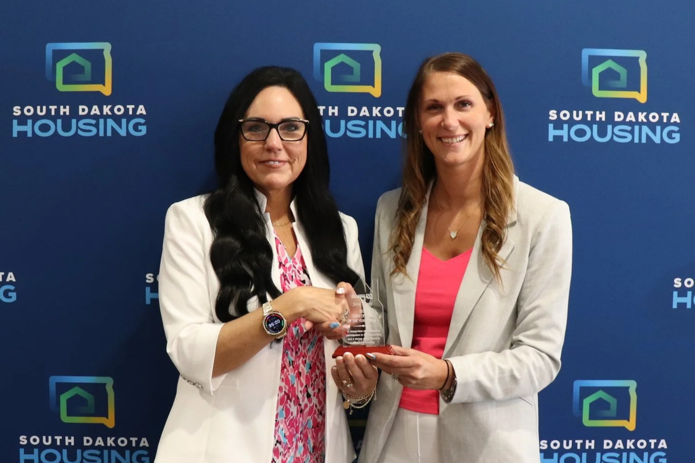 Janel Honke with First National Bank receiving her award from Homeownership Director Tammy Jund.