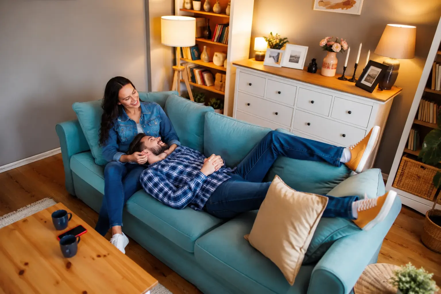 a woman and a man relaxing on their living room sofa