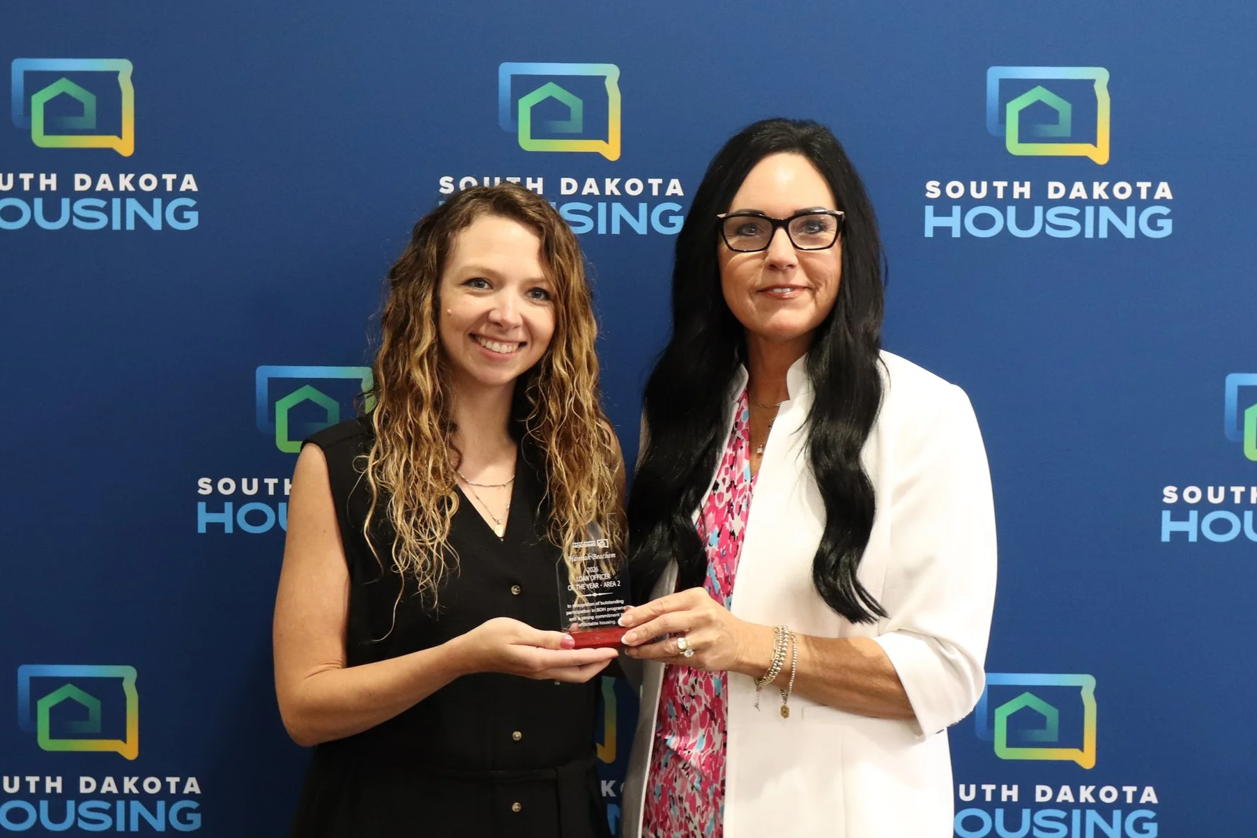 Hannah Beachem with Granite Mortgage receiving her award from Homeownership Director Tammy Jund