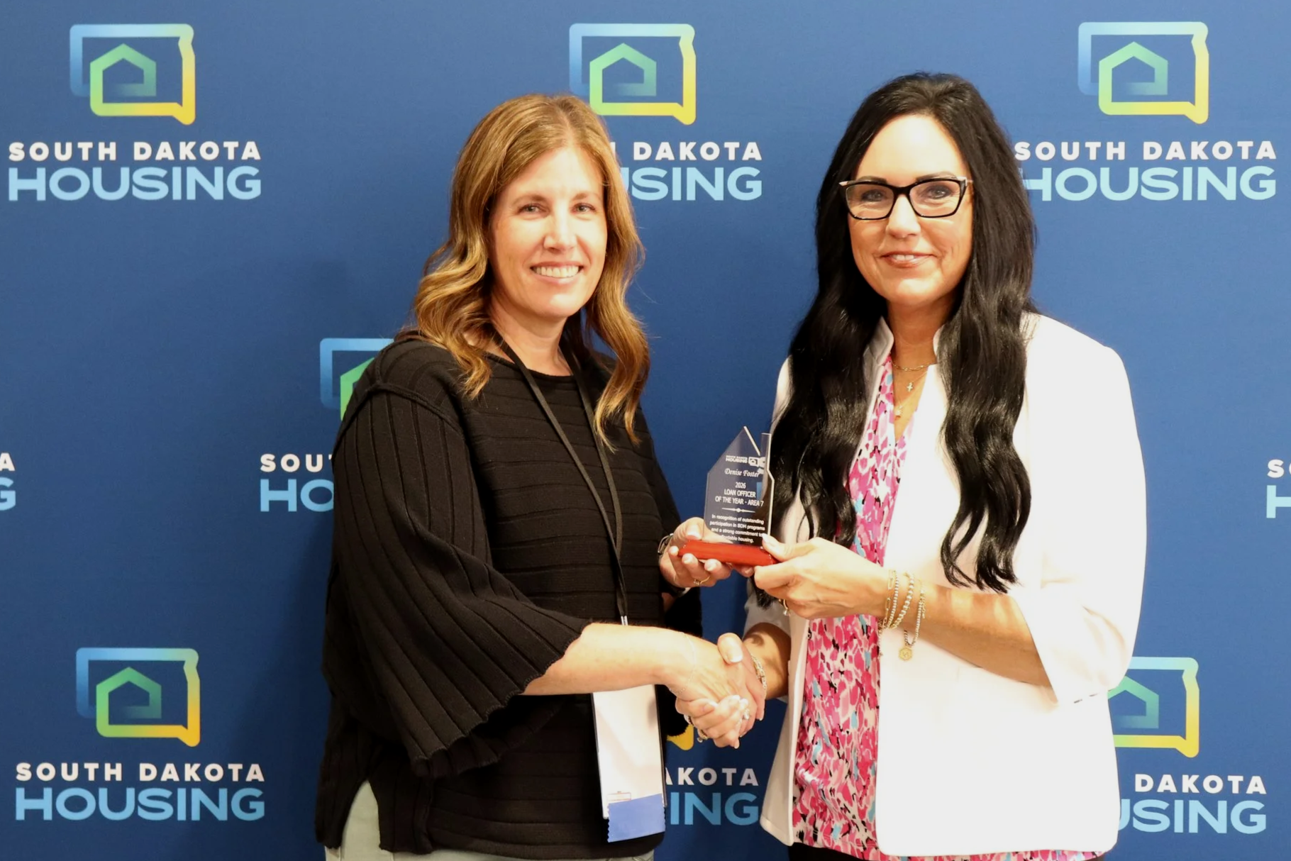 Denise Foster with BankWest receiving her award from Homeownership Director Tammy Jund.
