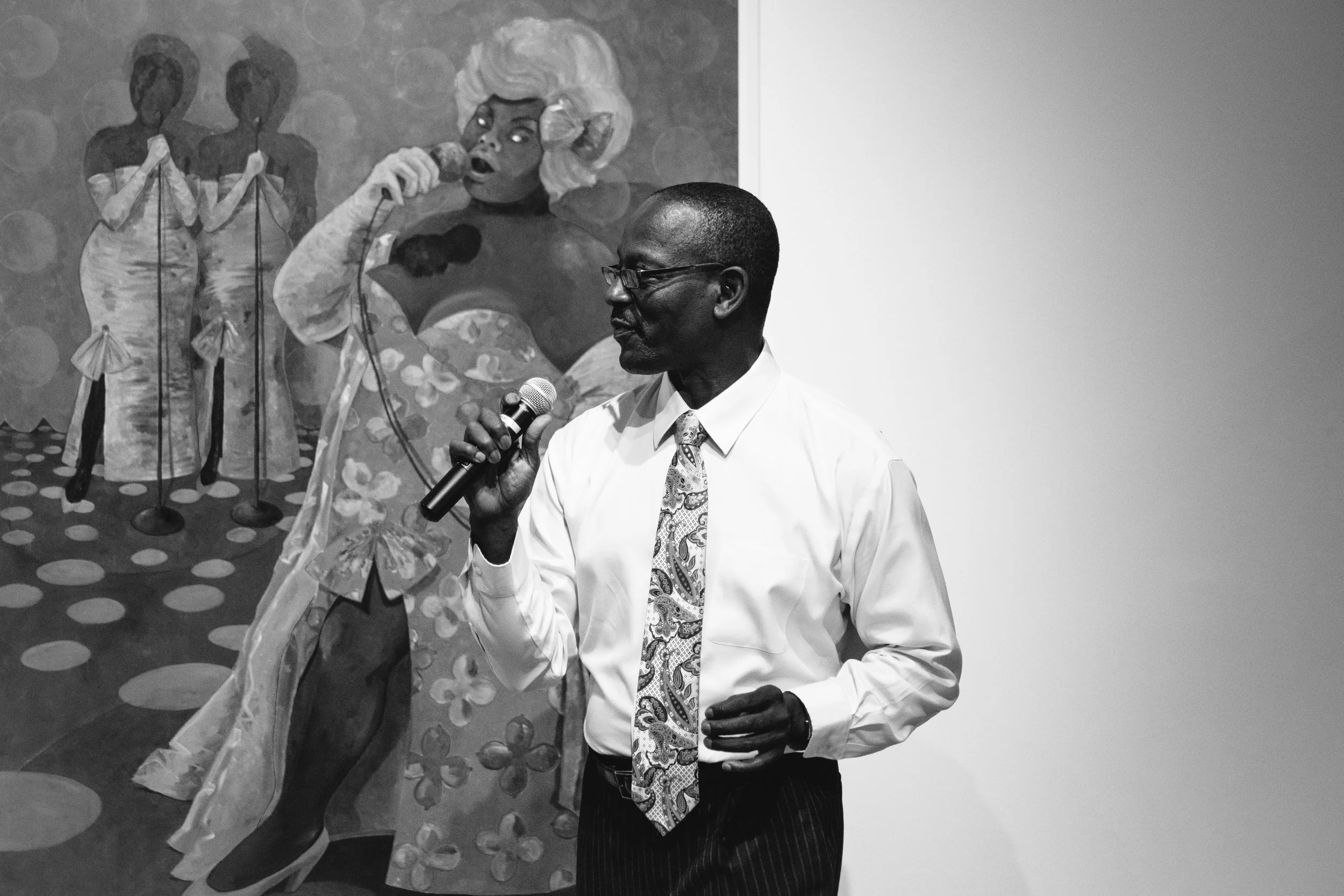 Floyd A. Smith of the 5th Dimension sings in front of a painting by Jonathan Green at SDSU Downtown Gallery