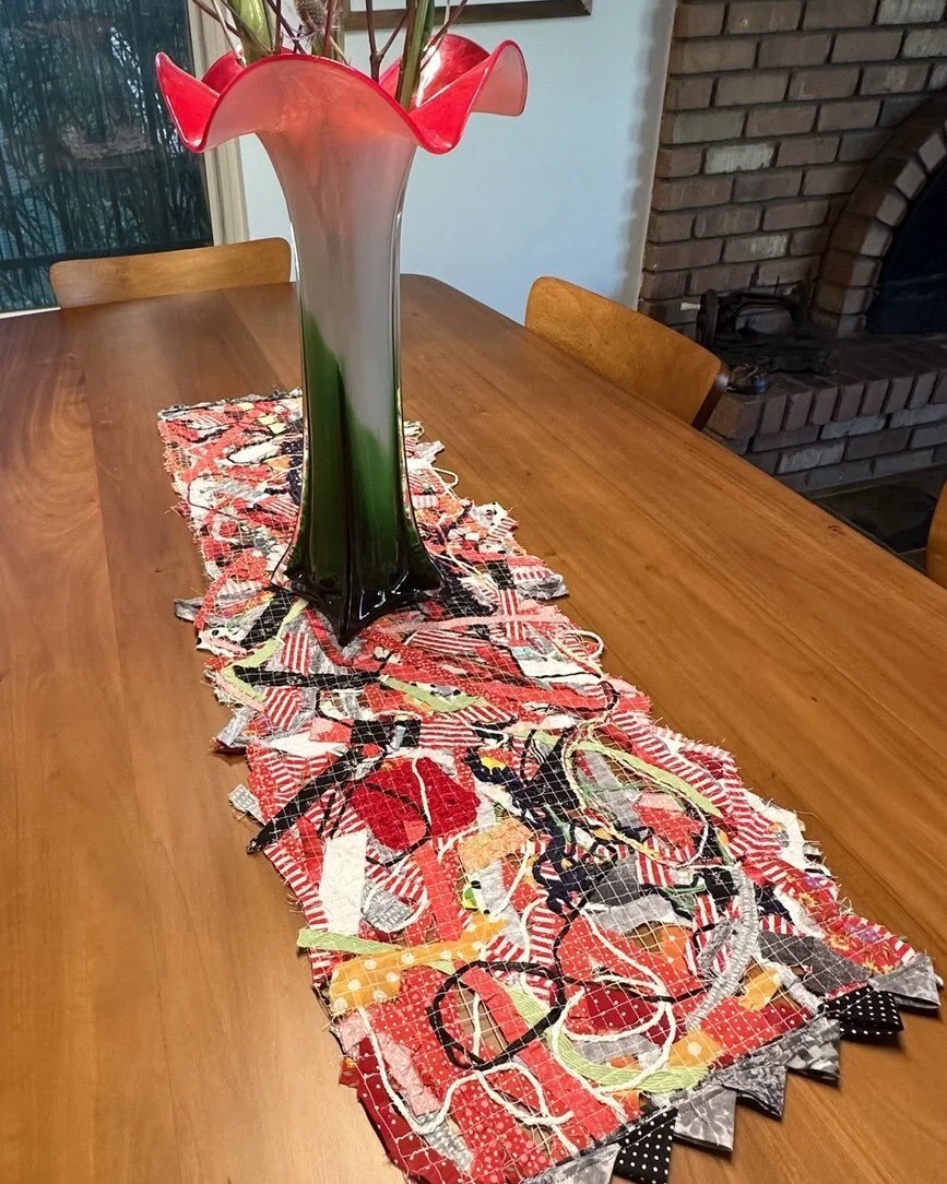 I recently taught a fiber arts how to make a table runner. Patricia who participated in the class shared her one of a kind masterpiece.  It is fabulous!  #modernquiltinaz #fiberarts#sewingarts#solvy#threadarts#sulky#scrappyart#scrapbuster