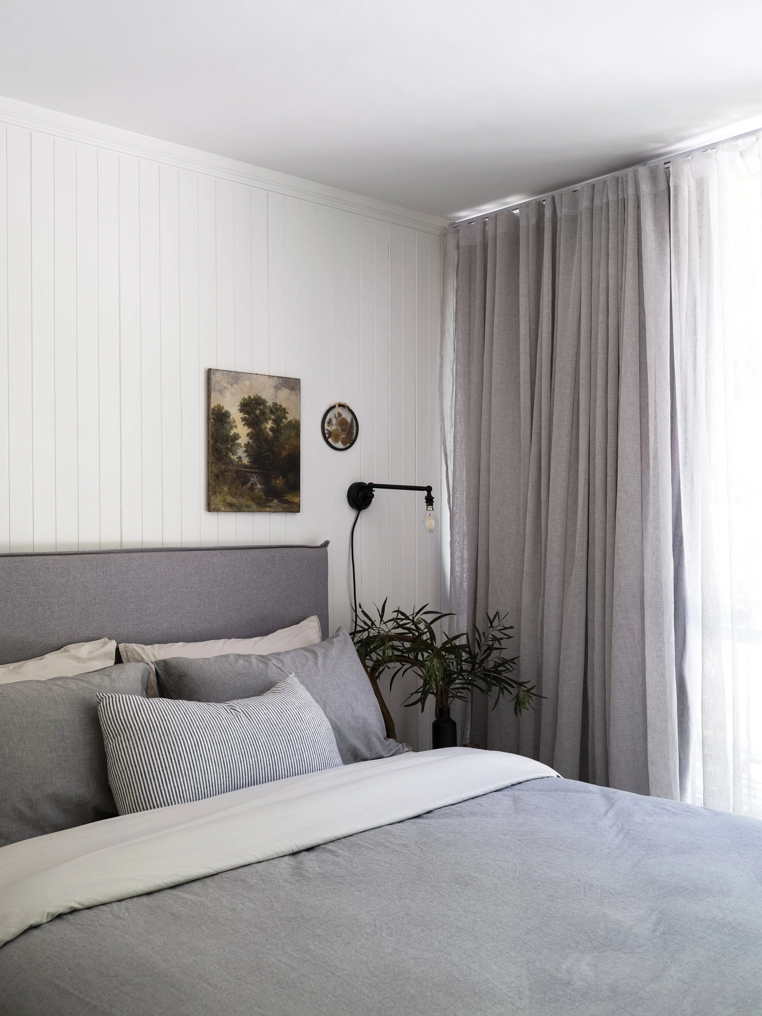 Peaceful queen bedroom at Seals Way with neutral linen and relaxed styling