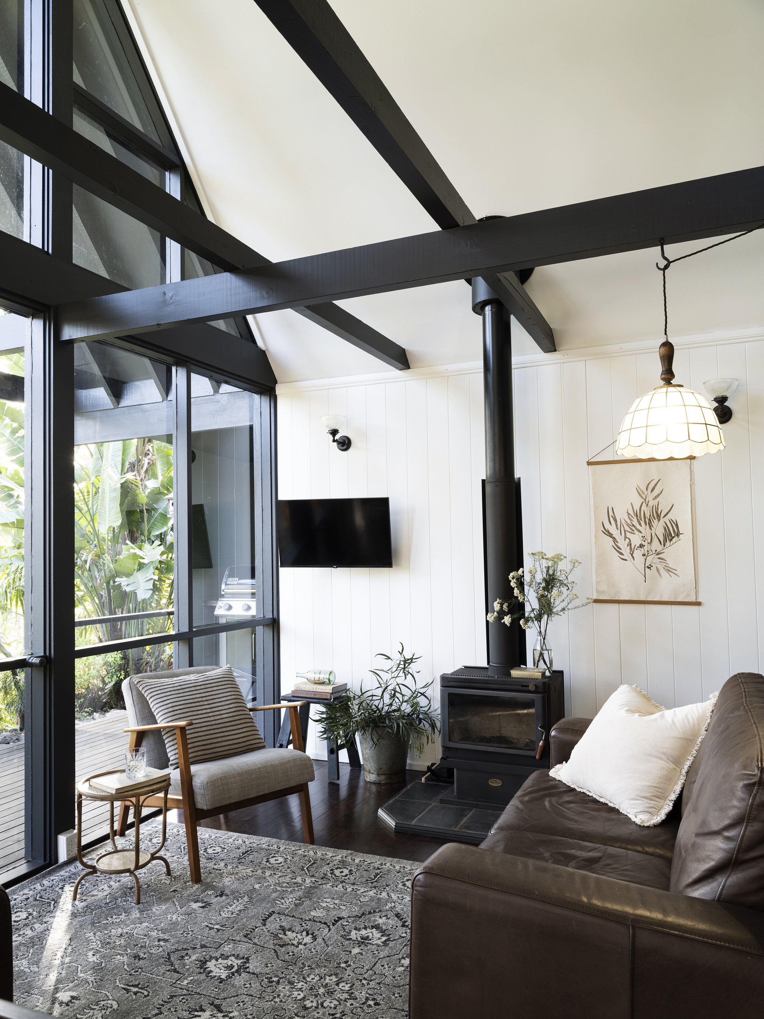 Seals Way lounge with natural light, timber beams, and forest outlook