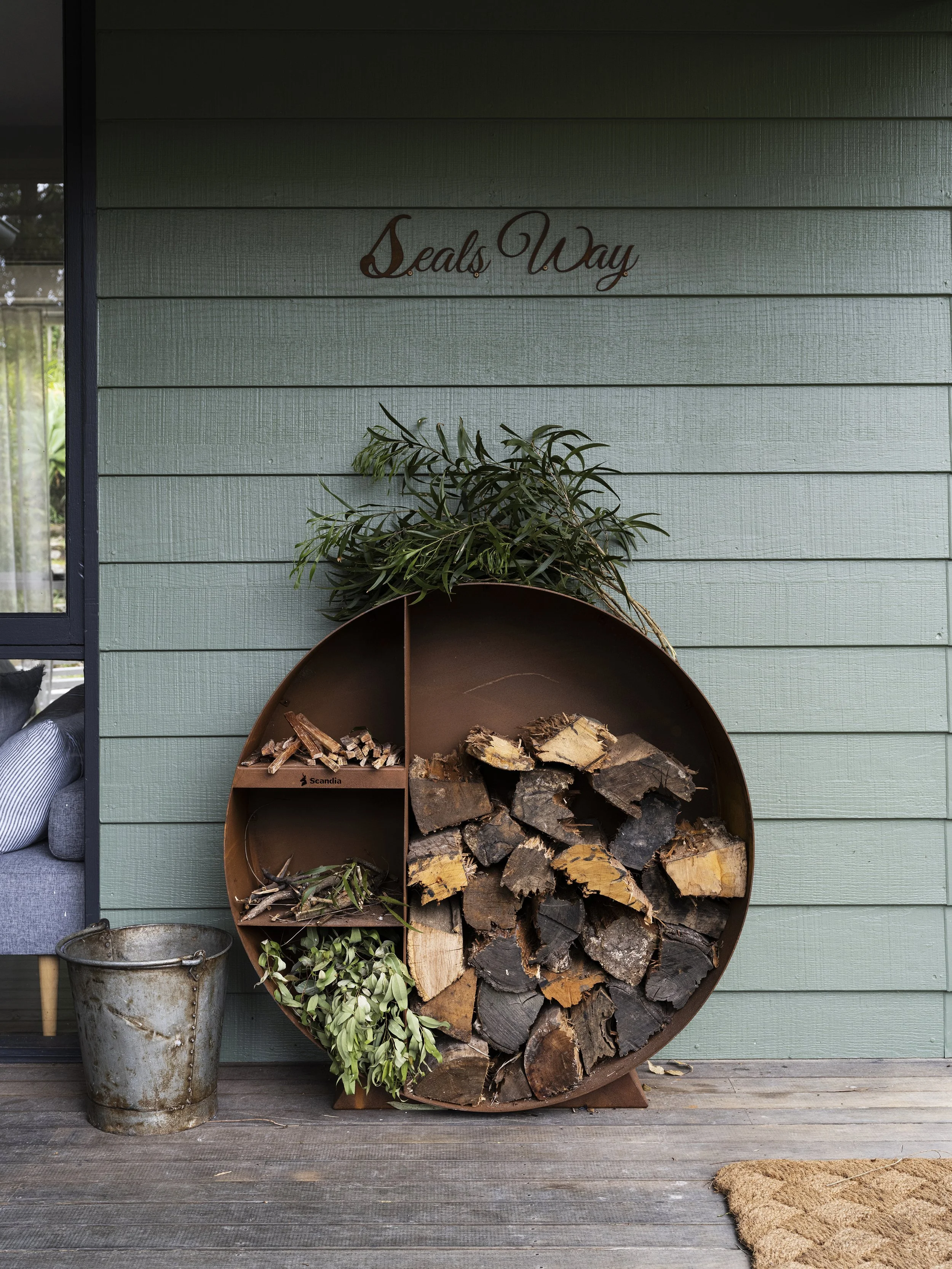 Outdoor setup at Seals Way featuring firewood, vintage tools, and rustic textures