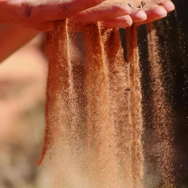 Hands letting sand fall through the fingers