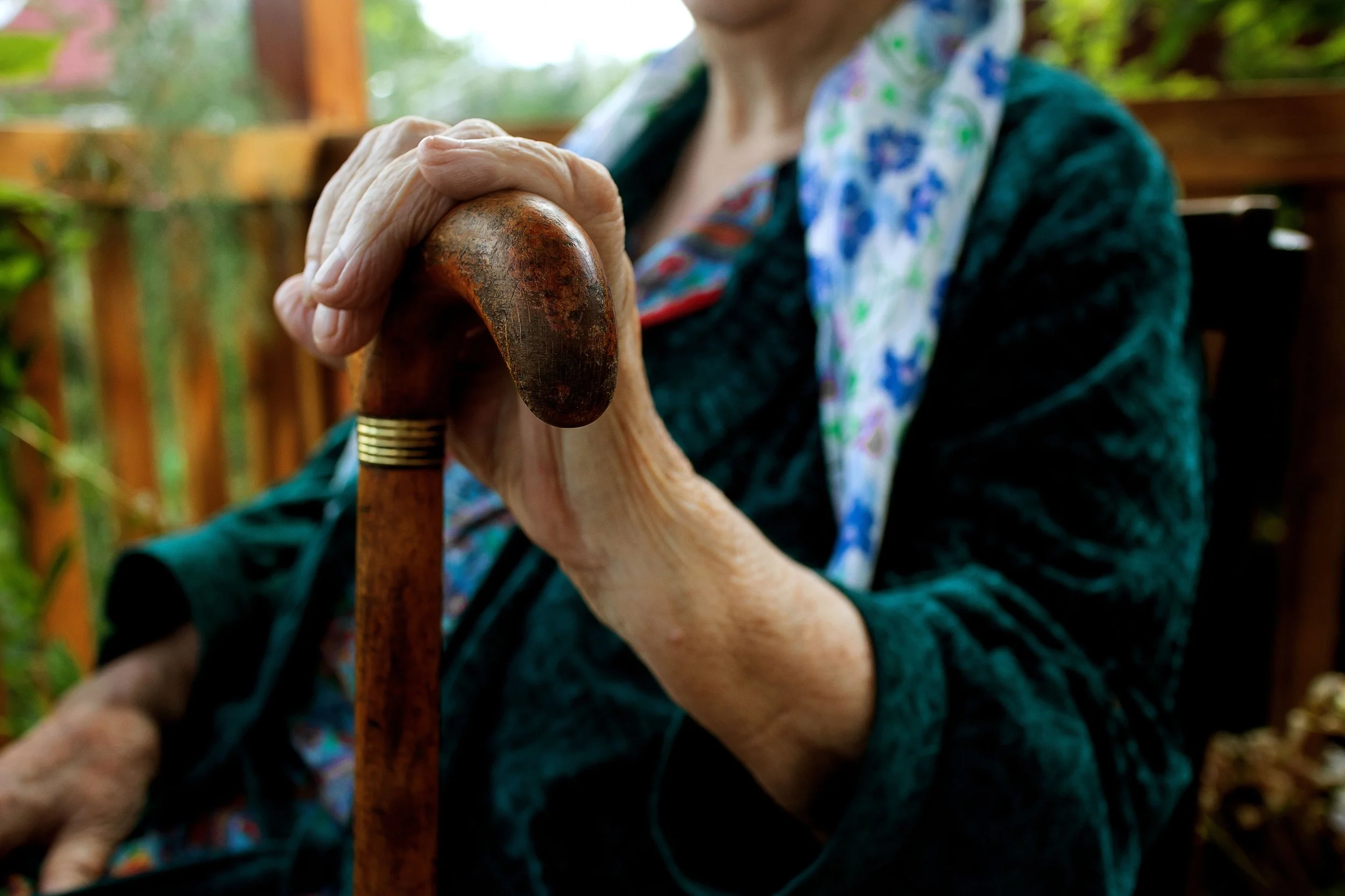 landing sitting with hand on walking stick