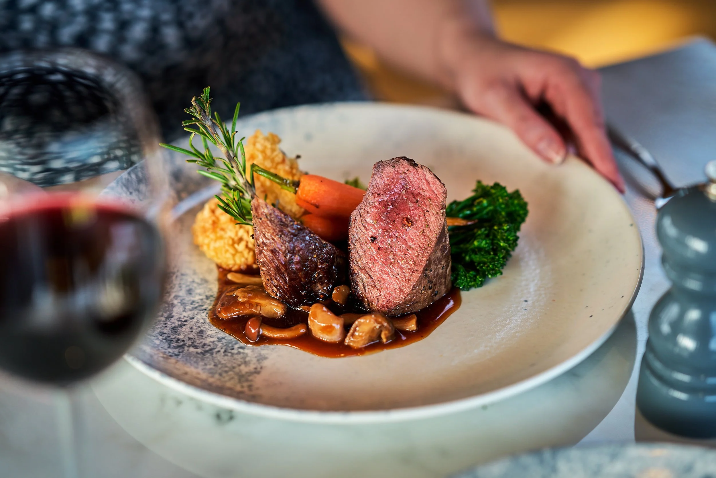 A large cut of venison served with fresh vegetables on the side.