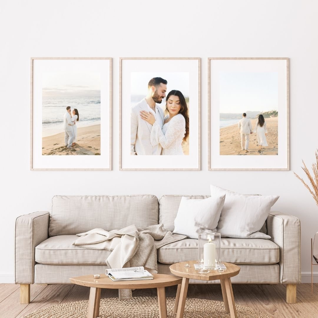 Summer Engagement Photos in Malibu displayed as three framed prints above a neutral sofa, showcasing romantic beach portraits and coastal scenery.