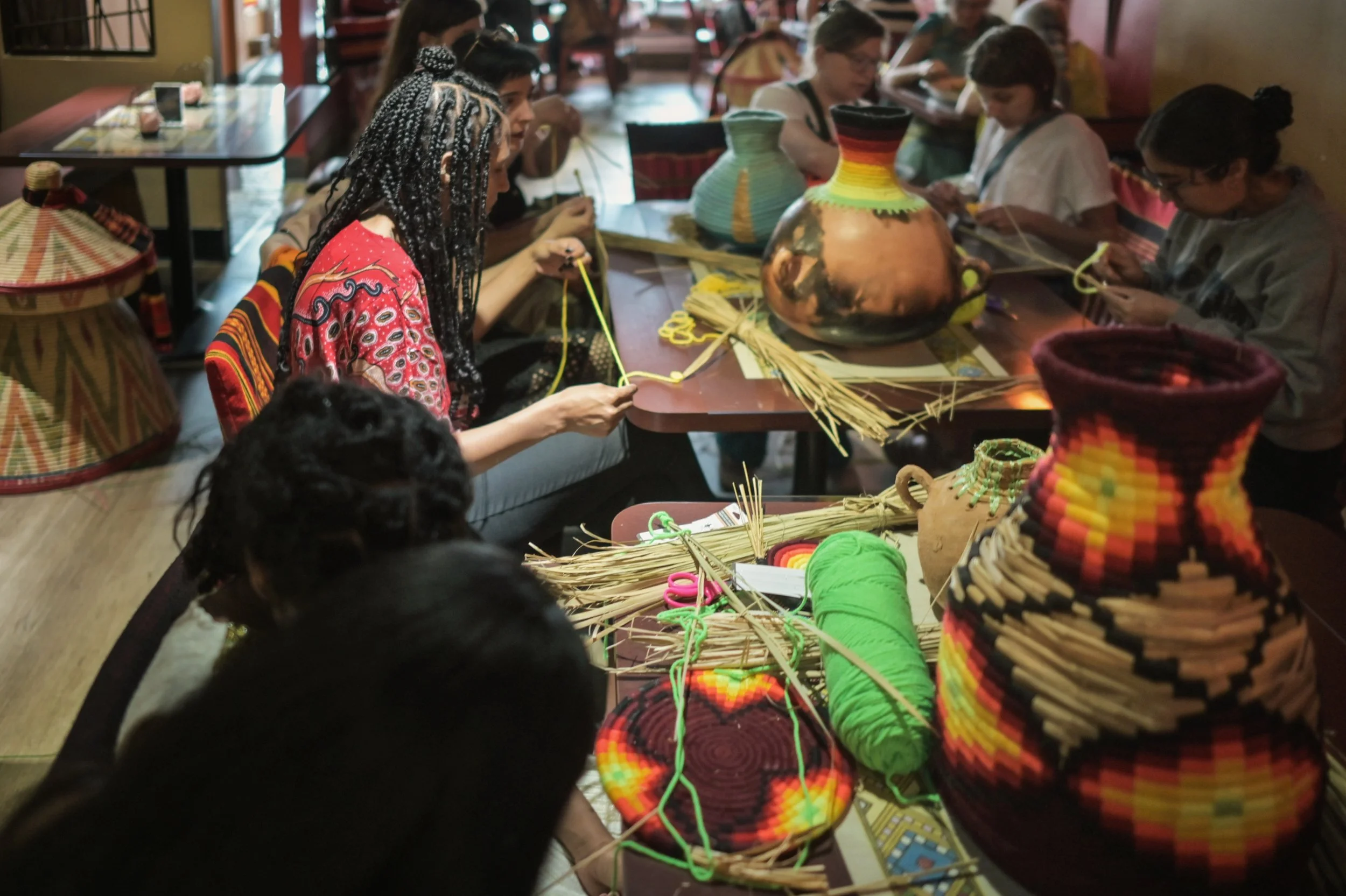 Participants of an Ethiopian basket weaving workshop at the 2026 Village Music Fest