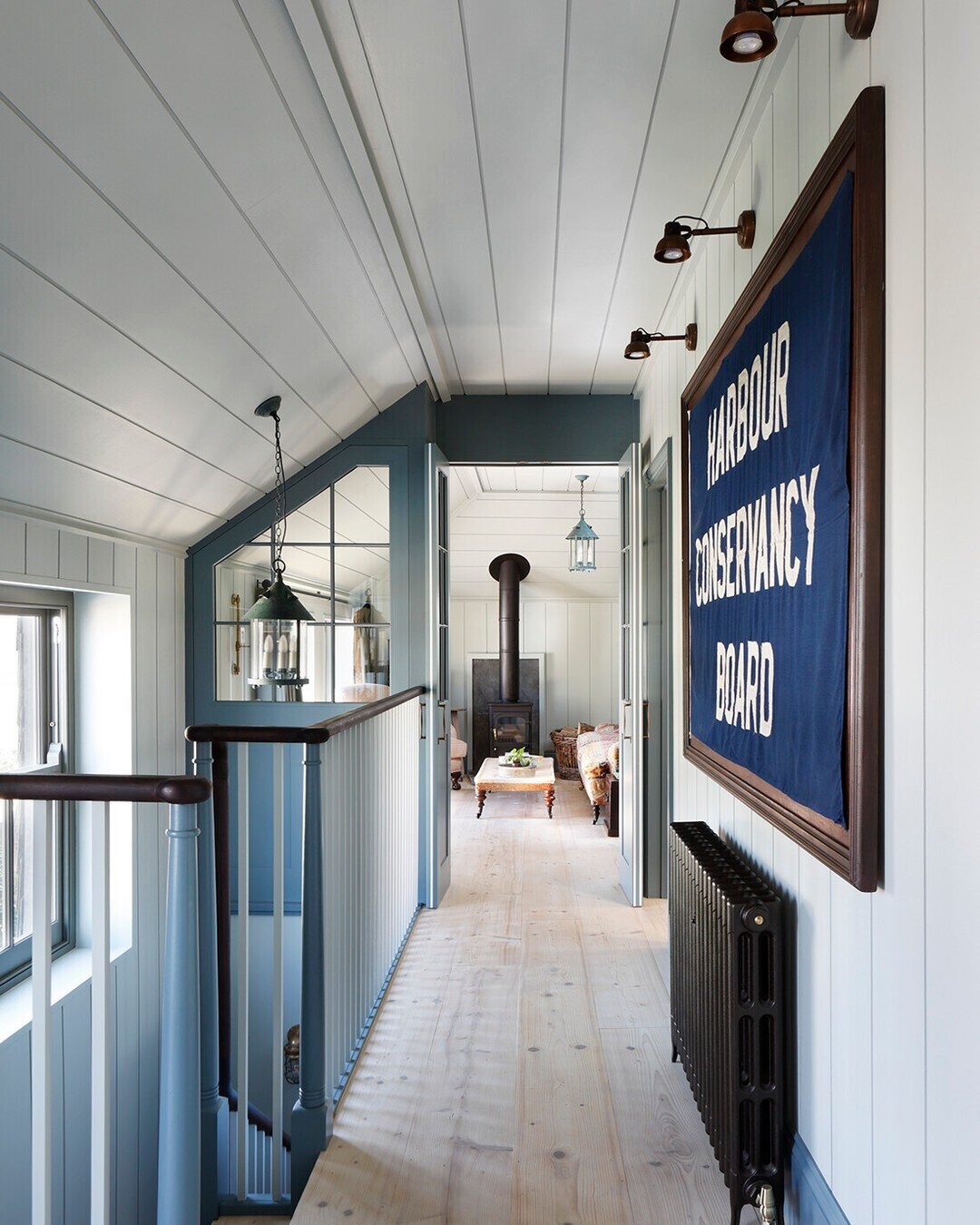 A connecting space is surely an unsung hero of the home. We wanted to make sure this landing had personality of its own. We commissioned an antique flag artwork at the centrepiece and placed carefully sourced objects &amp; antiques in pride of place 