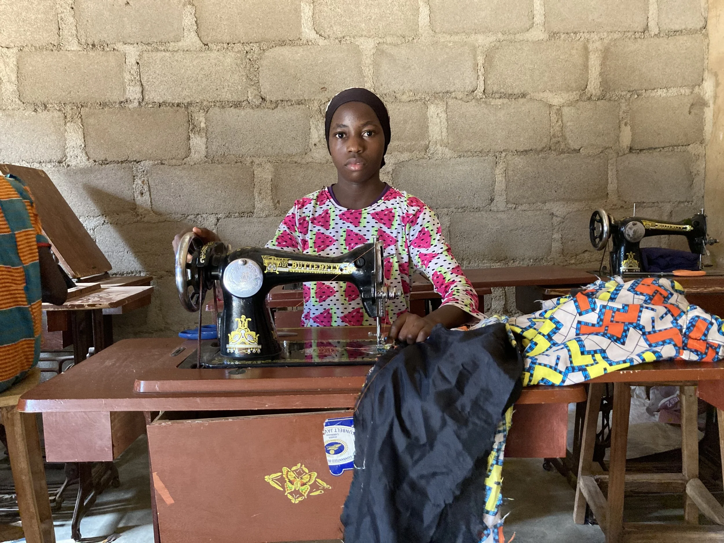 Student working at a sewing machine in Nigeria
