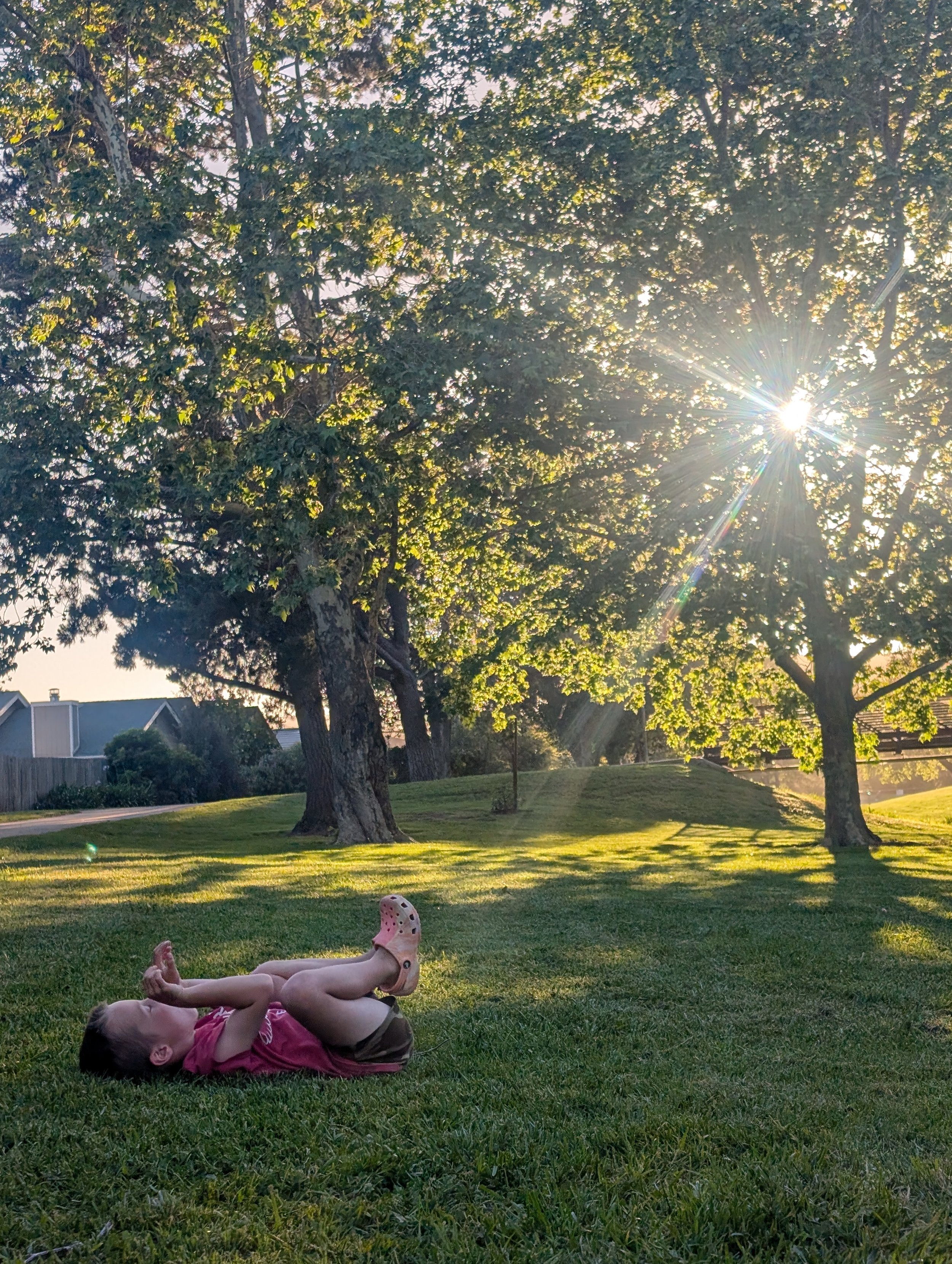 kid laying on ground at park