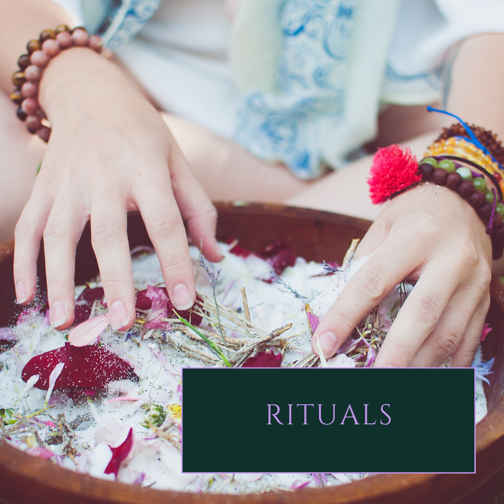 Rituals Service link close-up white person's hands mixing salt and herbs in a wooden bowl