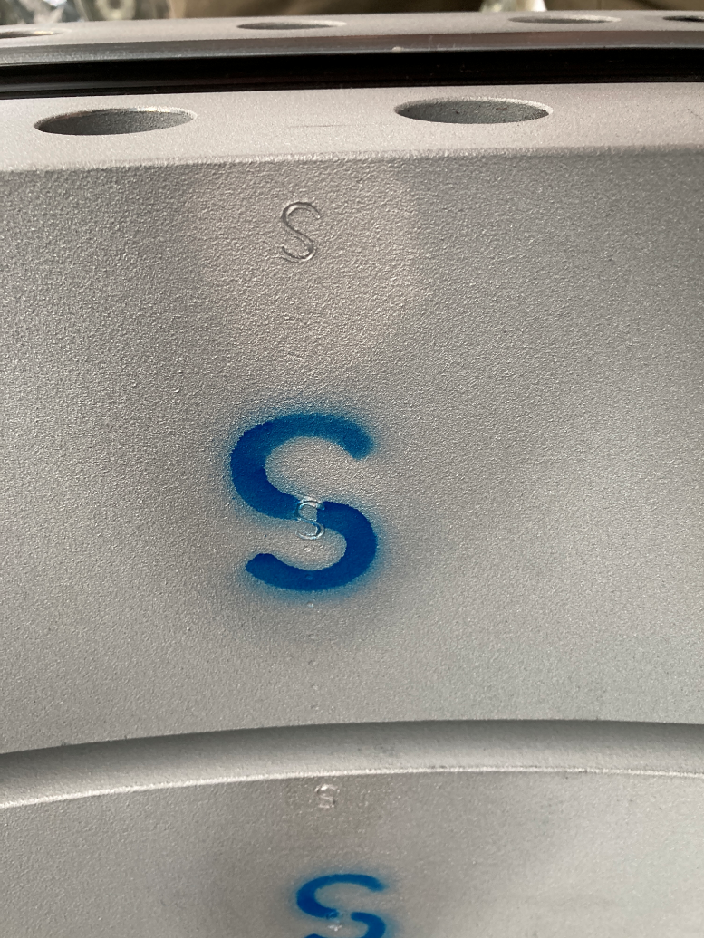 image showing s mark stamped and painted on a blade / pitch bearing. This mark indicates where the location of the internal raceway soft spot is. This is often used in determining mounting orientation during installation.
