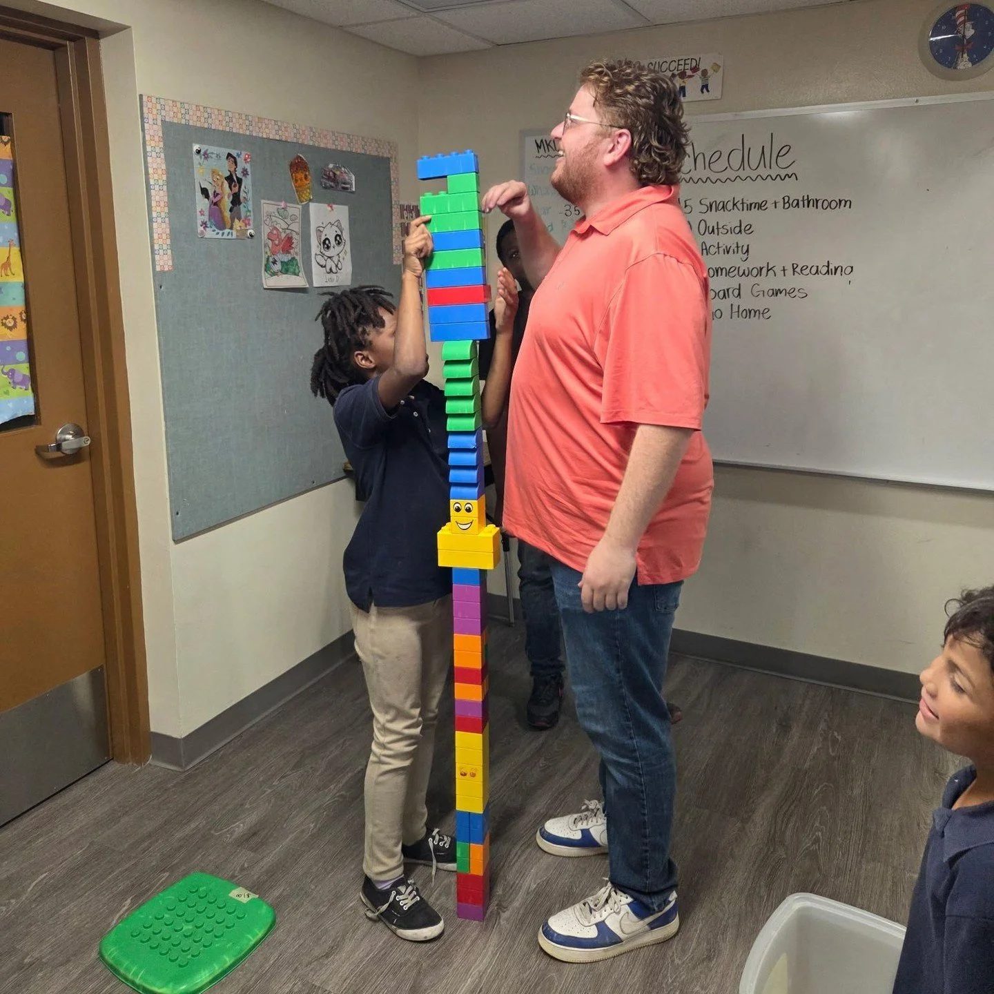 Building leaders who build leaders!!! 

Not only does MentorKids build leaders who build leaders we also build leaders who BUILD such fun things with Lego blocks! Our Volunteer Phillip is over 6 feet tall and the kids made a super tall block building