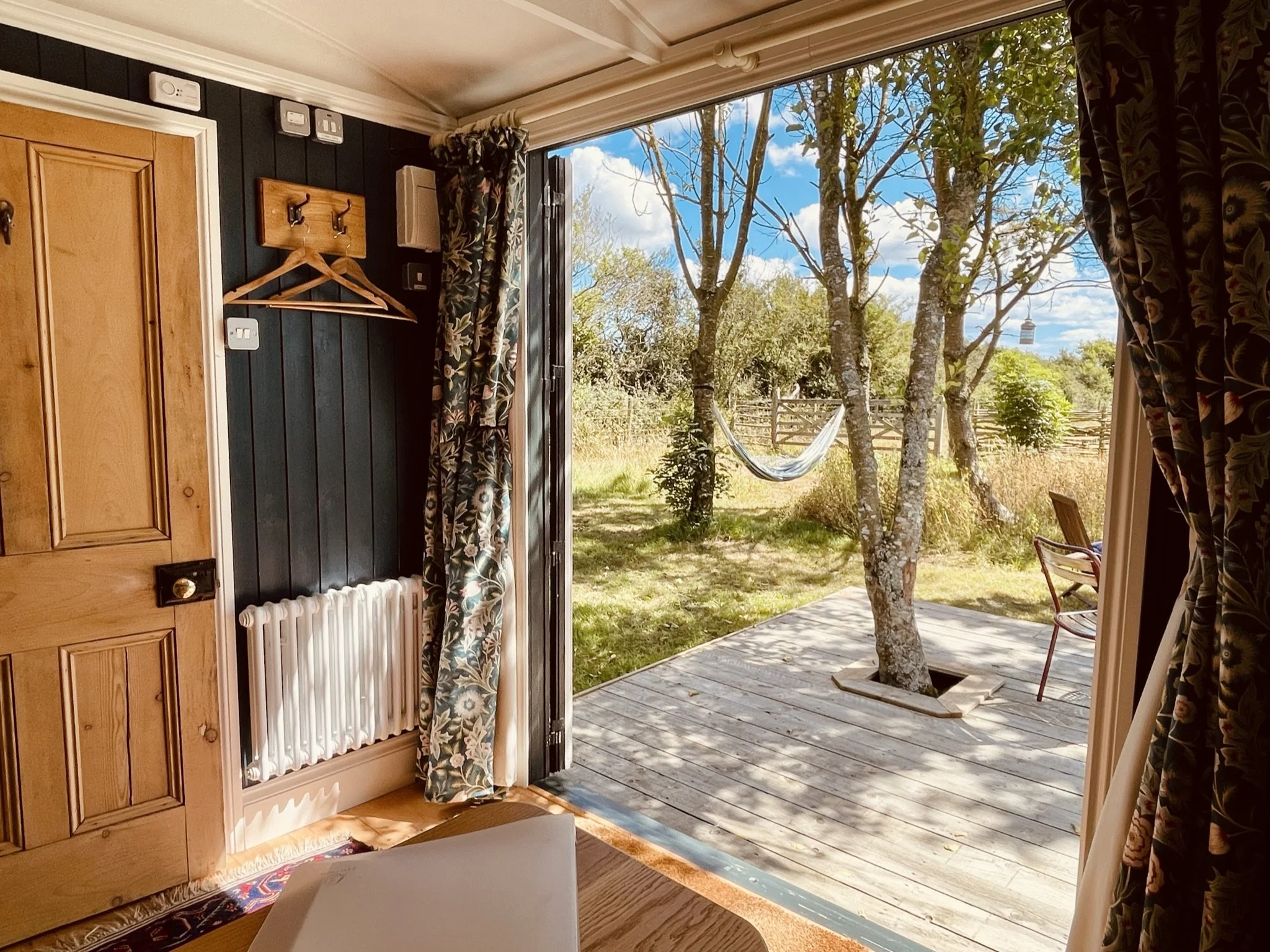 Looking out over The Field Room deck into garden with hammock