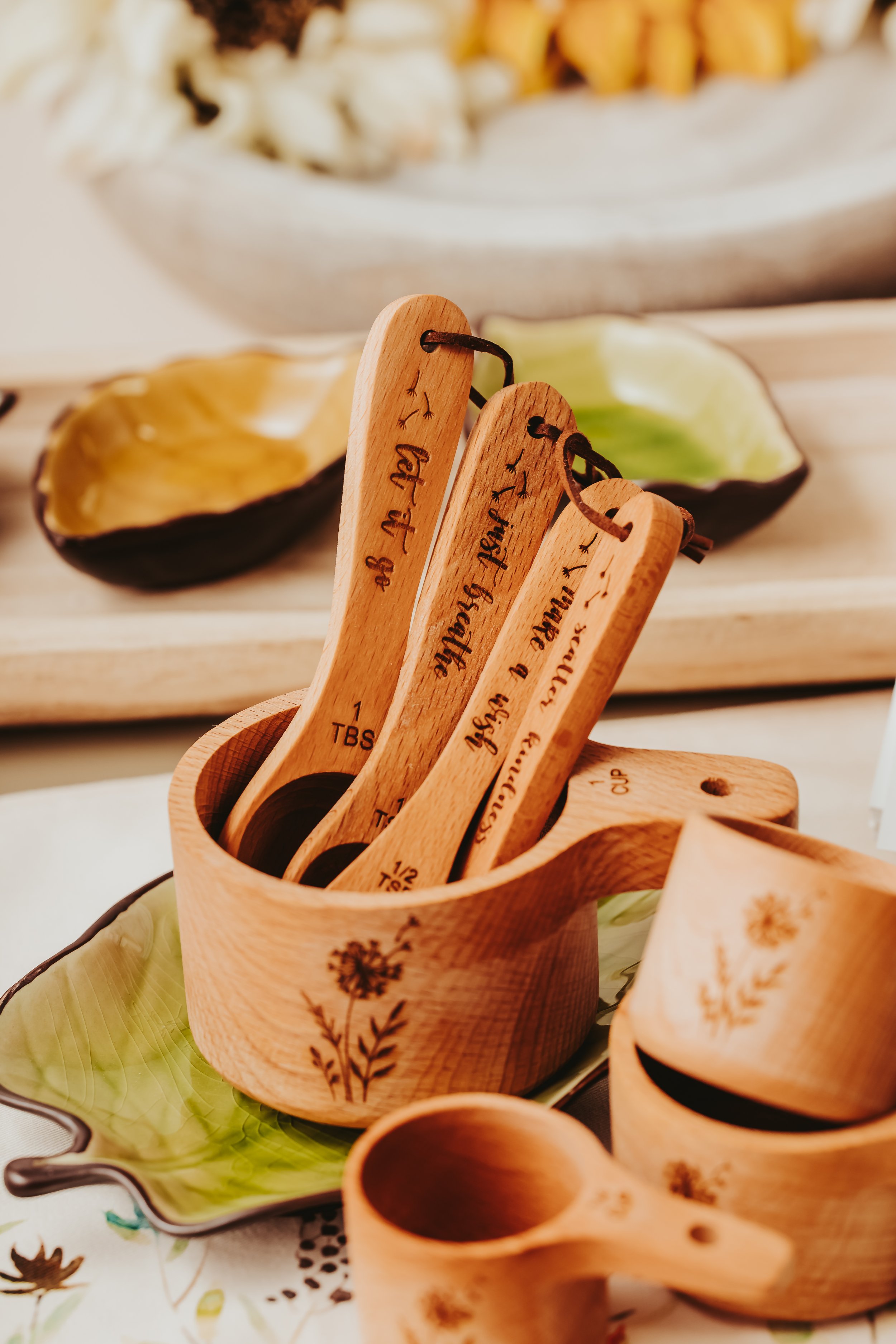 lifestyle photography of laser engraved wooden measuring cup with measuring spoons resting inside