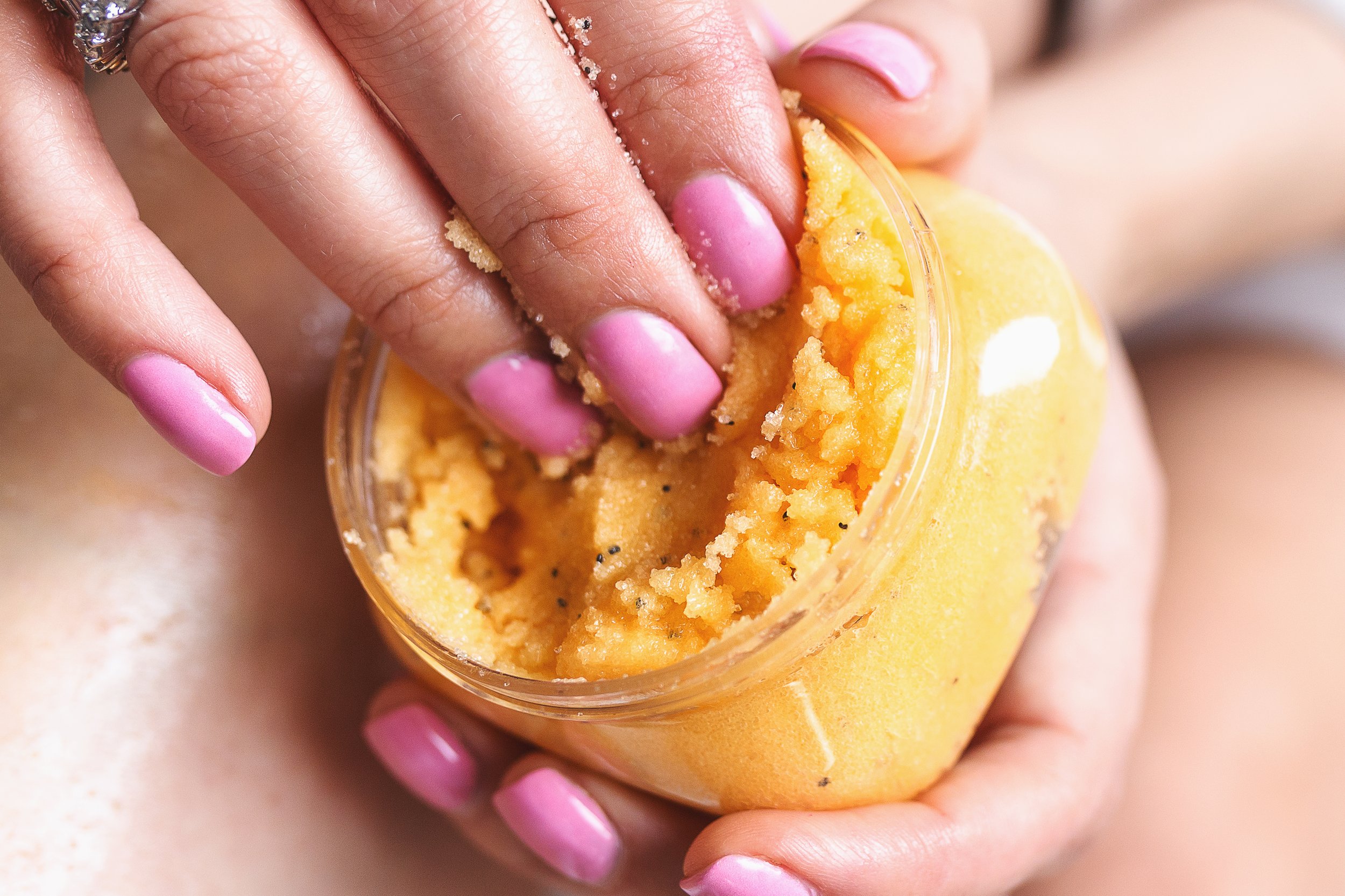 hand model holding and using handmade body scrub