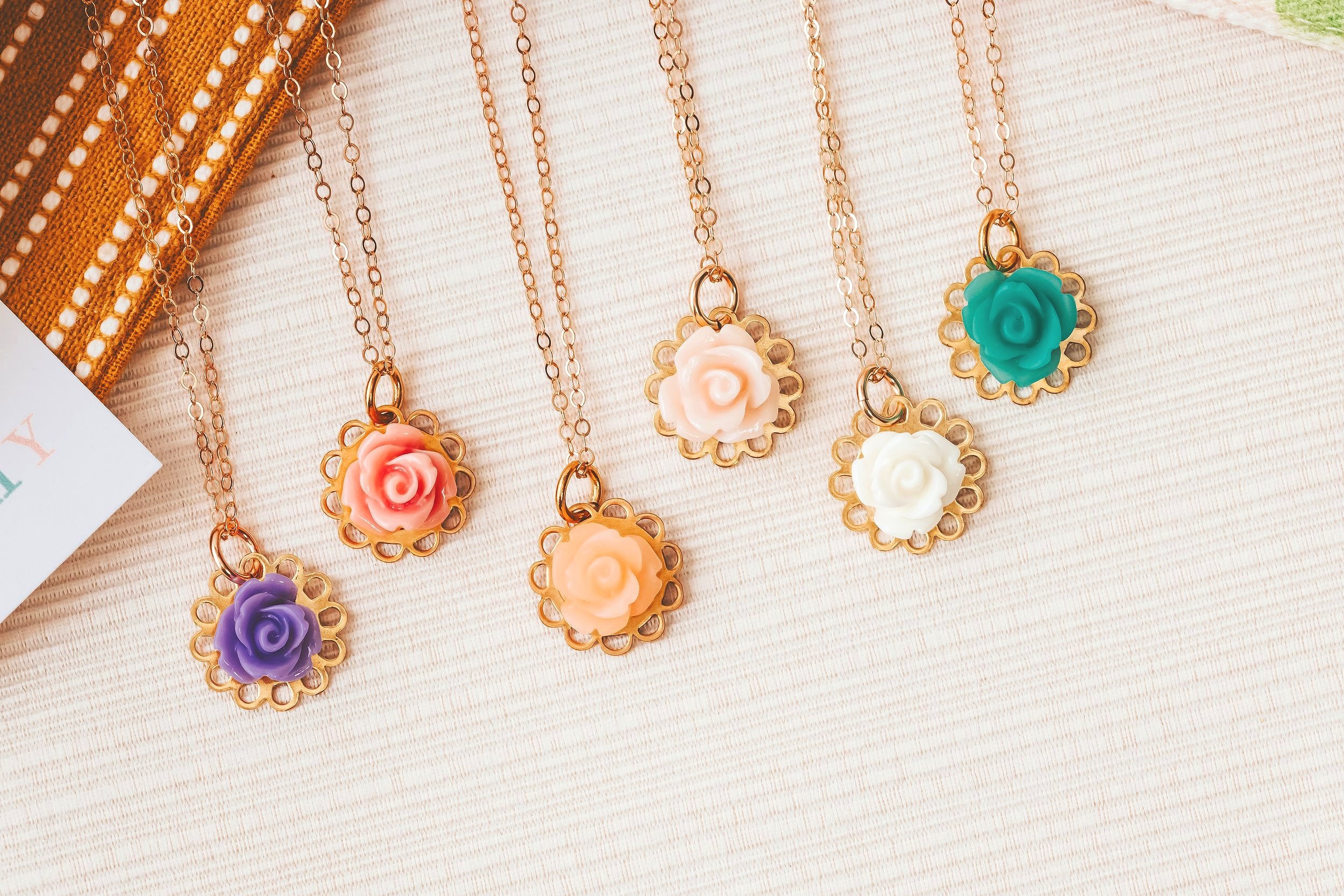 flower charms on necklaces flat lay product photography