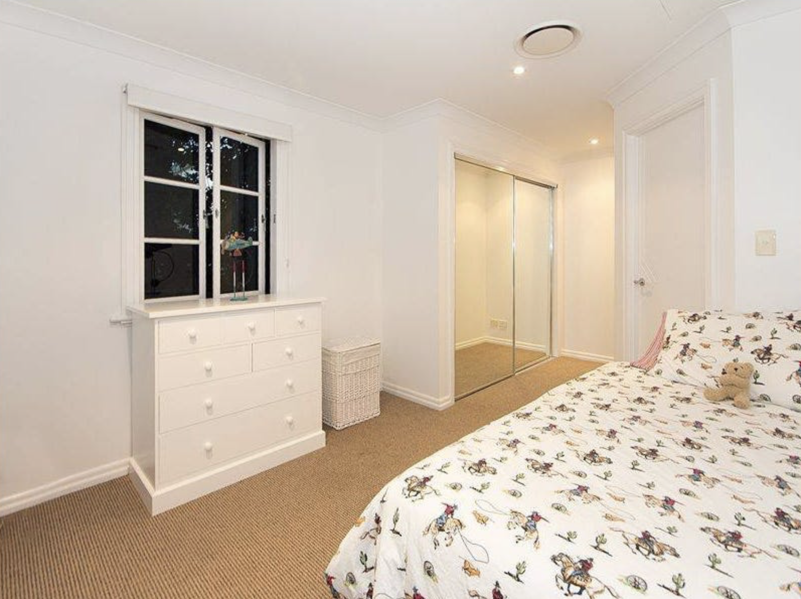 The spare bedroom before renovations. The wardrobe space was converted to an ensuite.