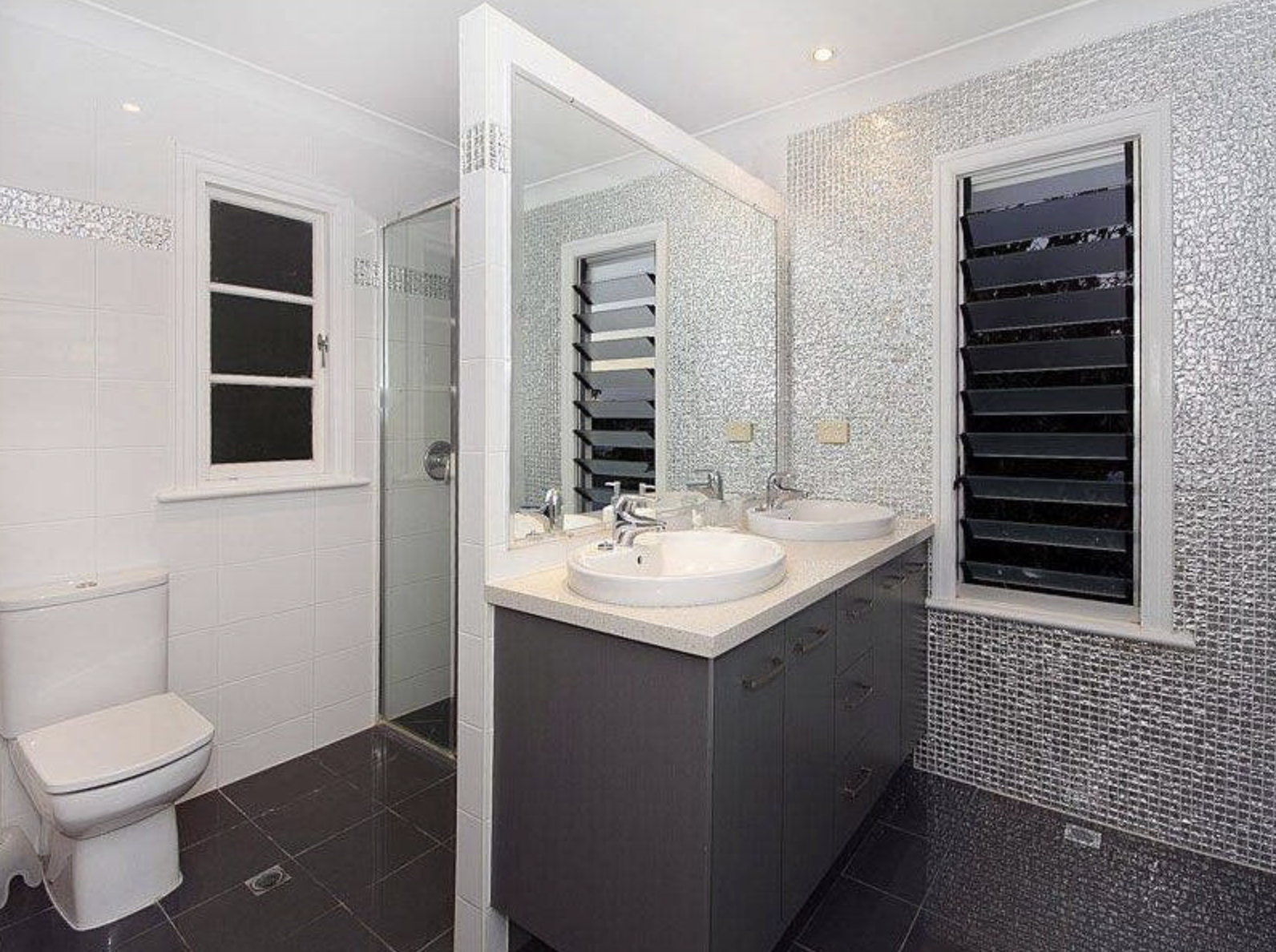 The main bedroom ensuite before the renovations. The room was enlarged by incorporating the small, dysfunctional walk in robe. A freestanding bath was added and the space was completely modernised.